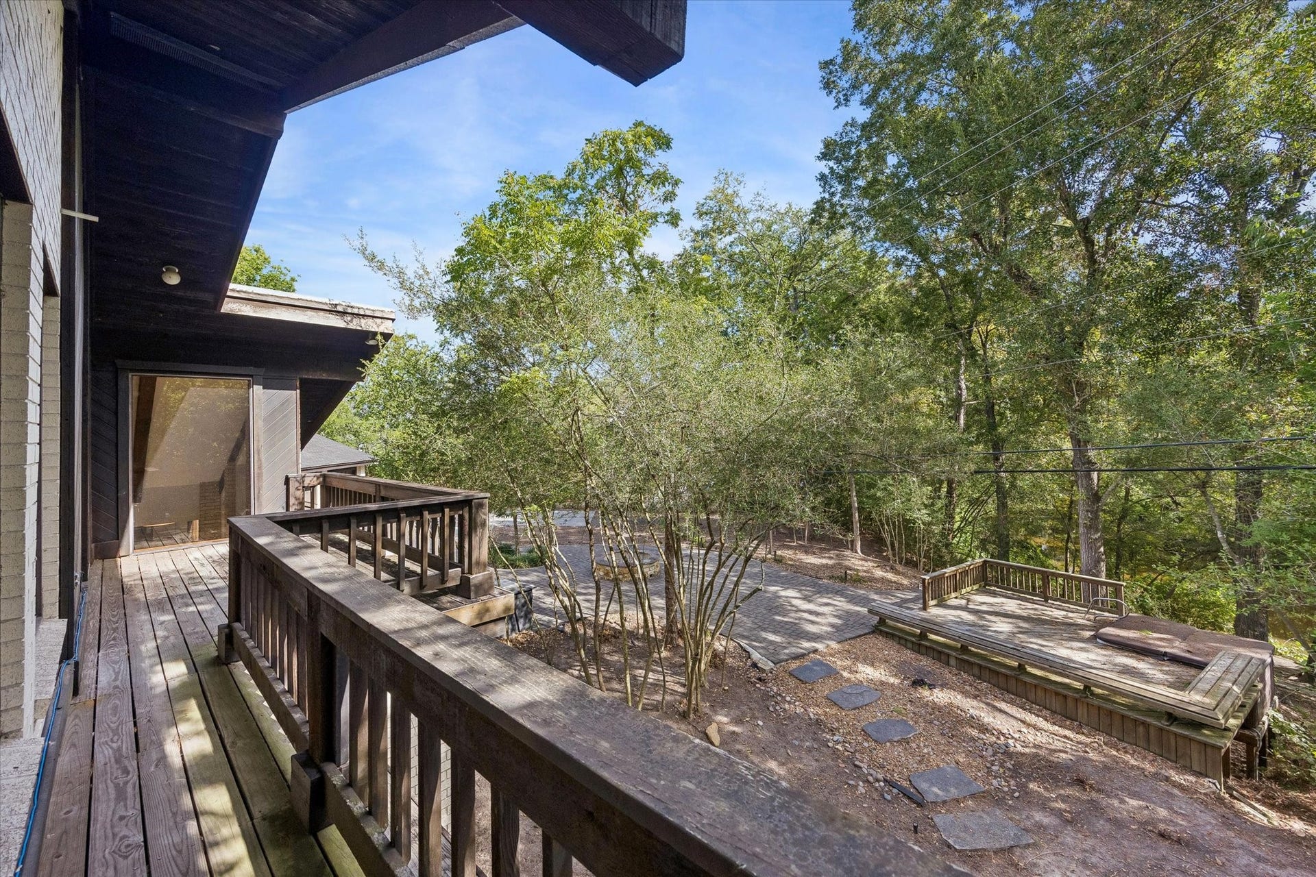104 Gershwin Drive, Houston, TX 77079 Wraparound porch connects the primary suite & office while overlooking the tree-filled grounds, creating an inviting outdoor space to relax & enjoy the natural setting.
