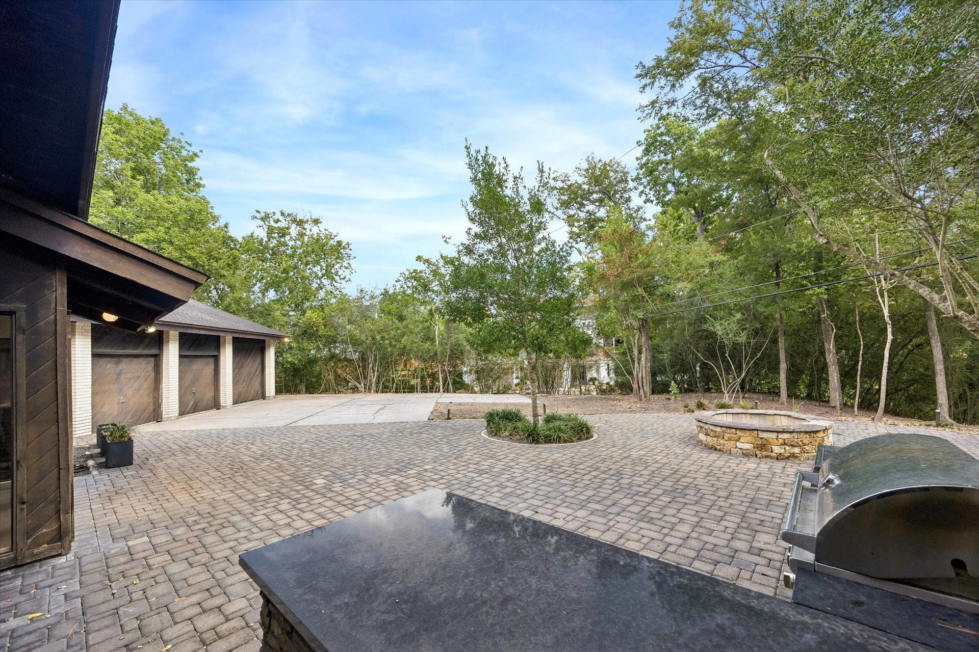 104 Gershwin Drive, Houston, TX 77079 Another view of the expansive patio highlights the built-in outdoor kitchen, fire pit & incredible amount of space for outdoor dining, entertaining & gathering.