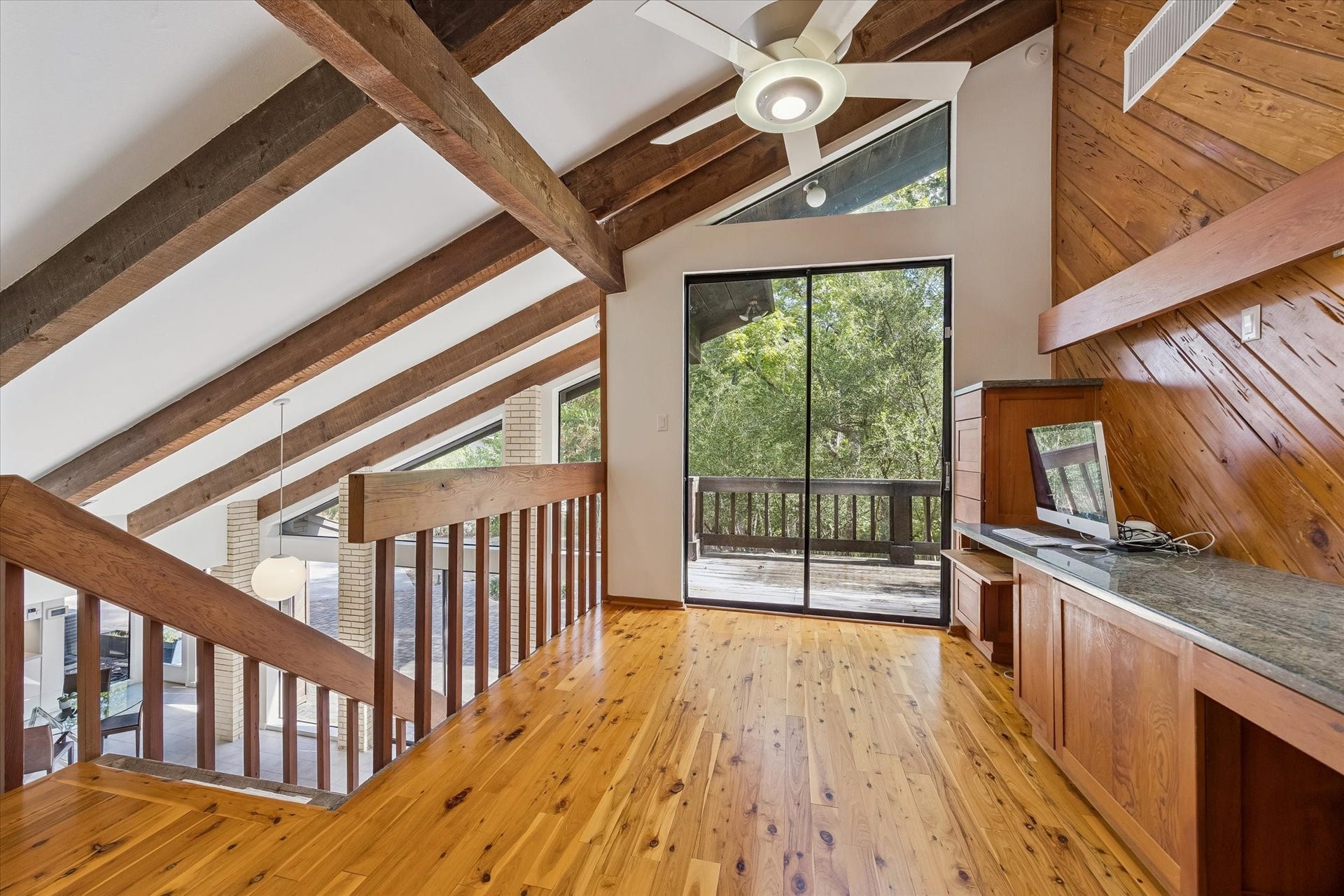 104 Gershwin Drive, Houston, TX 77079 Another view highlights the offices gorgeous Pecky Cypress floors, exposed beams & built-in workspace, while sliding glass doors provide natural light & direct access to the wraparound porch.
