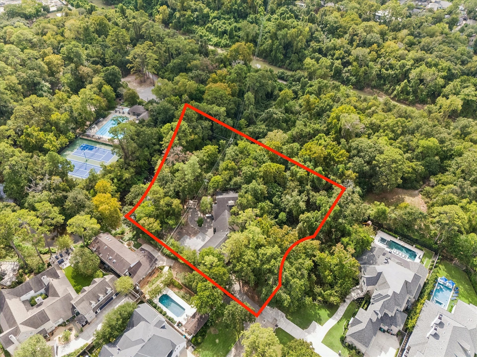 104 Gershwin Drive, Houston, TX 77079 Aerial view showcases the incredible 69,552 SF lot (per HCAD), surrounded by mature trees & offering a rare combination of space, natural beauty & opportunity.