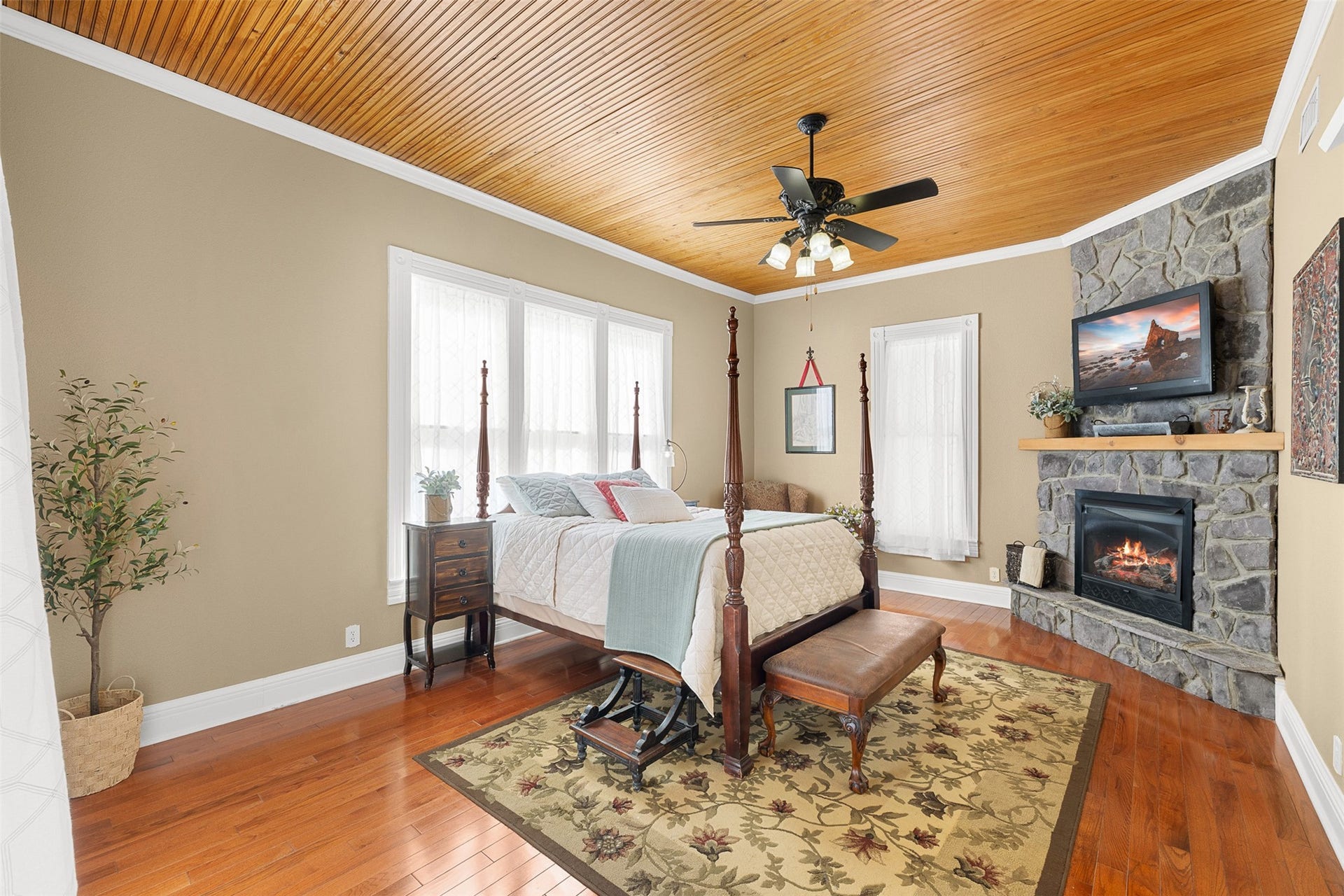 326 W Colorado Street, La Grange, TX 78945 The first-floor primary bedroom is a serene retreat with warm wood floors, a beadboard ceiling and its own fireplace.