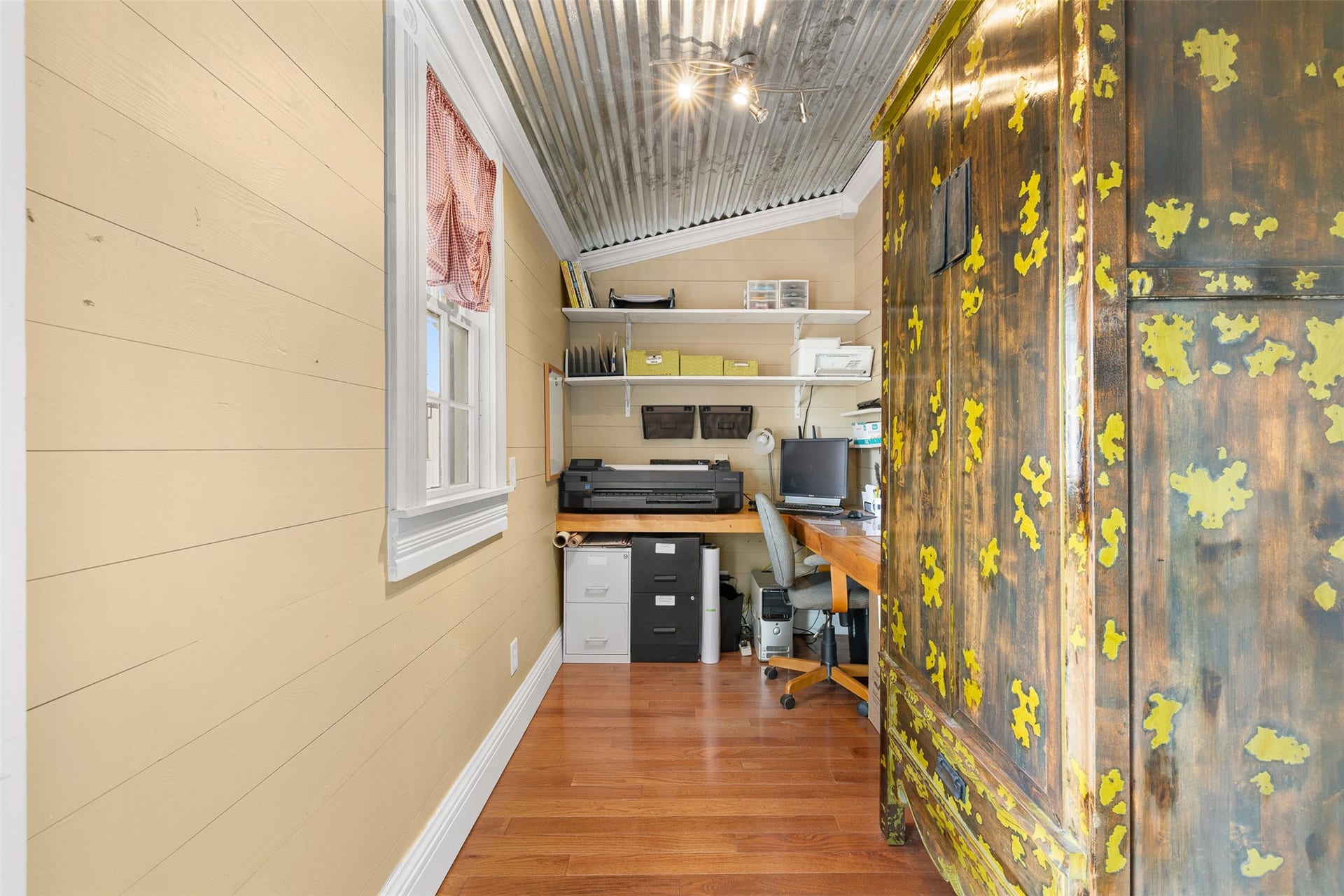 326 W Colorado Street, La Grange, TX 78945 A tucked-away home office makes thoughtful use of space with natural light, wood flooring and open shelving.
