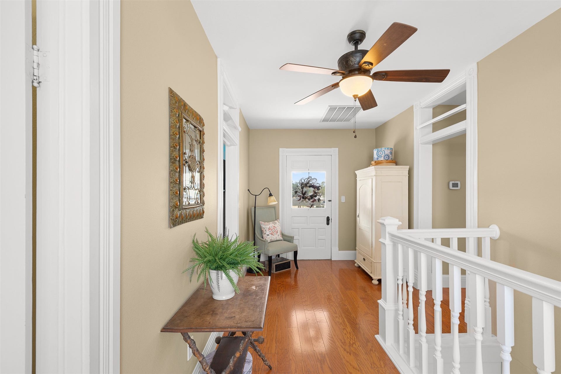 326 W Colorado Street, La Grange, TX 78945 The upstairs landing connects the secondary bedrooms and opens toward the homes sweeping upper balcony.