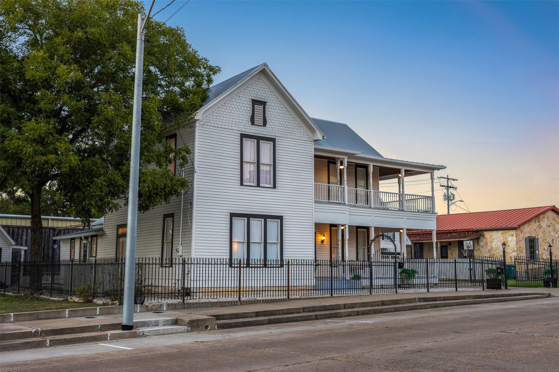 326 W Colorado Street, La Grange, TX 78945 As evening falls, the homes crisp Victorian architecture takes on a warm and romantic glow.