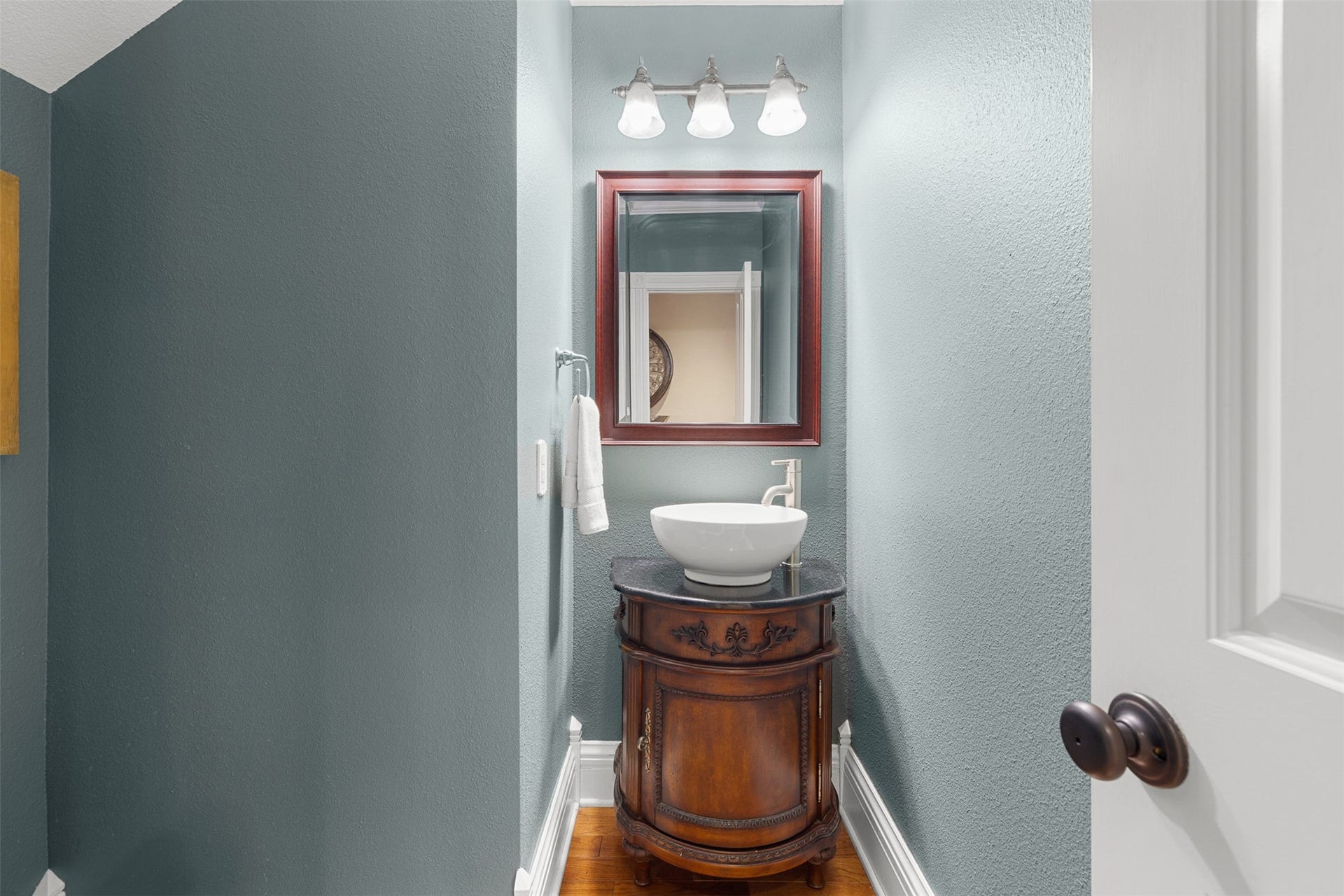 326 W Colorado Street, La Grange, TX 78945 Tucked beneath the staircase, the charming powder room makes clever use of the homes historic floor plan.