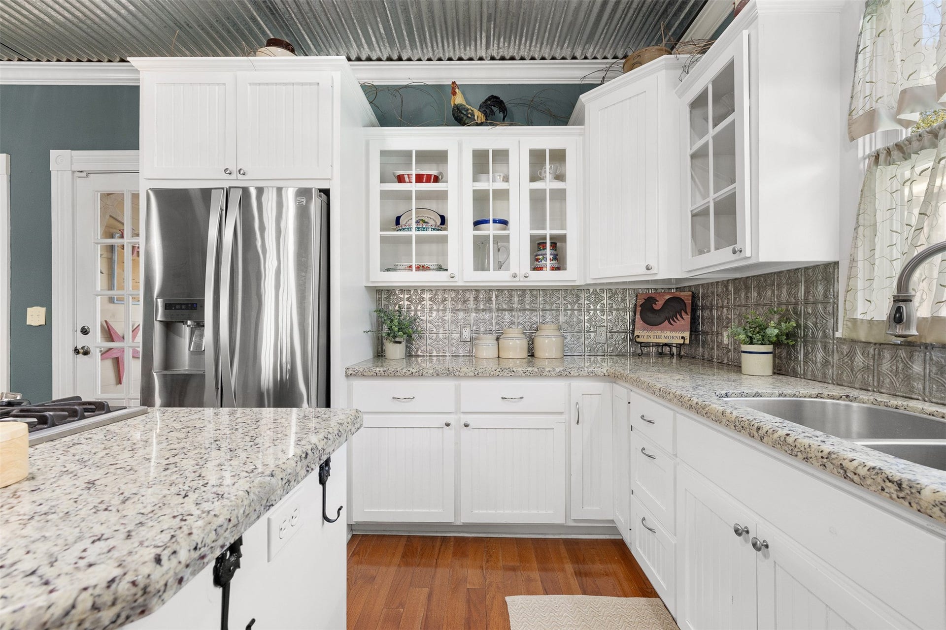 326 W Colorado Street, La Grange, TX 78945 Glass-front cabinetry, granite surfaces and thoughtful storage bring style and function to the updated kitchen.