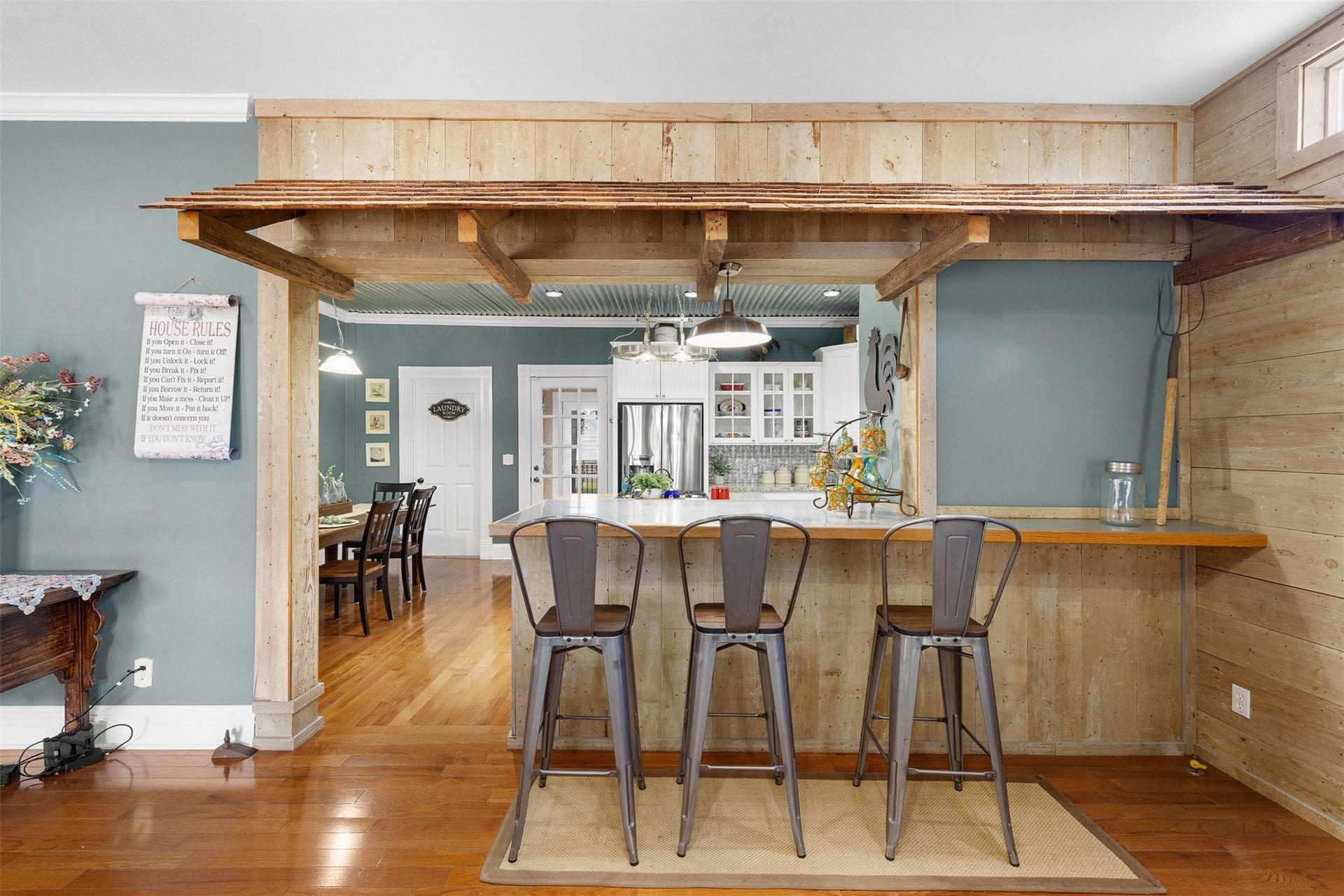 326 W Colorado Street, La Grange, TX 78945 A character-filled bar fashioned from original wood, nails and cheesecloth connects the family room with the dining and kitchen areas.