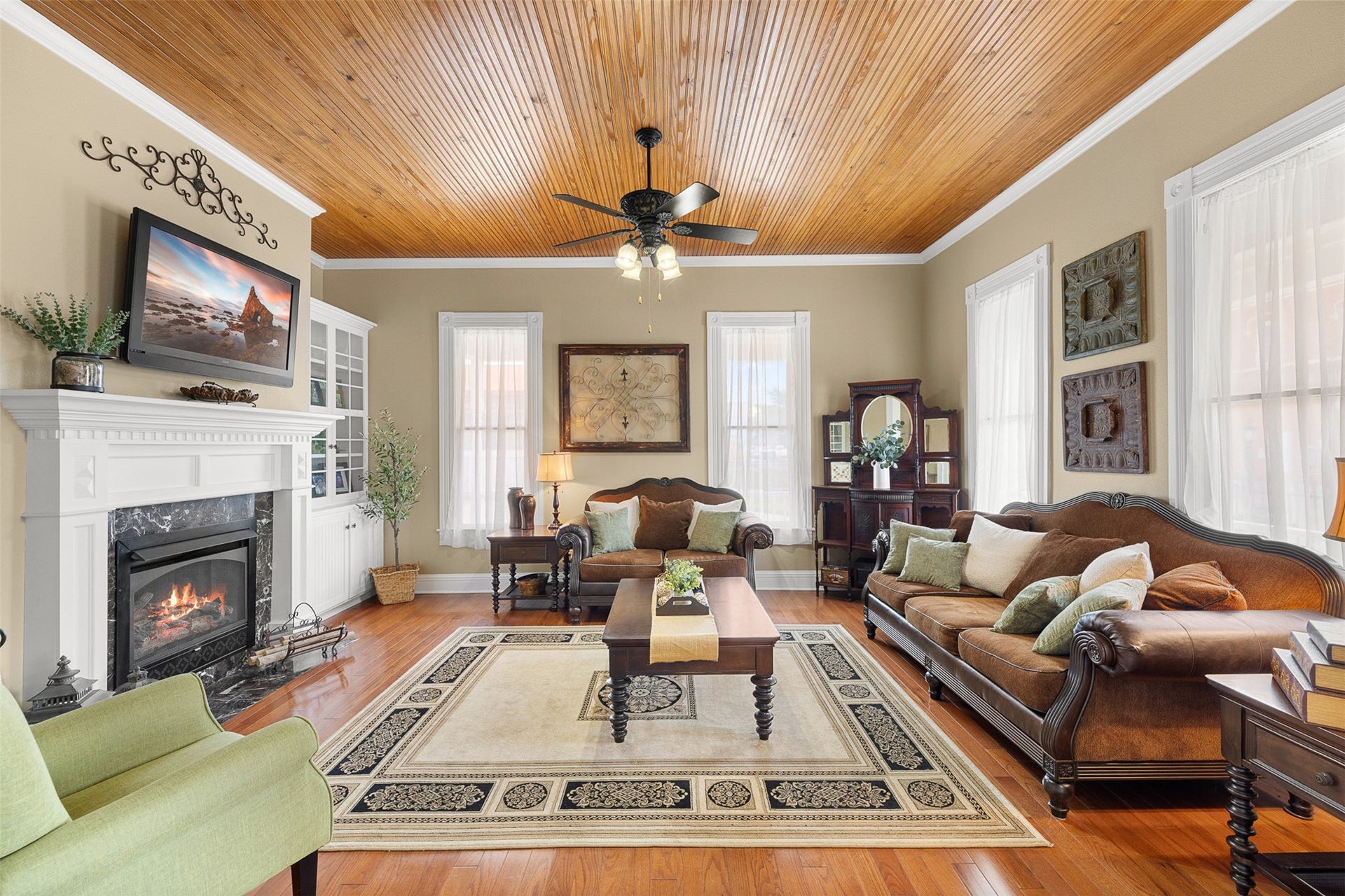 326 W Colorado Street, La Grange, TX 78945 The formal living room pairs soaring ceilings and warm wood floors with a fireplace, built-ins and abundant natural light.