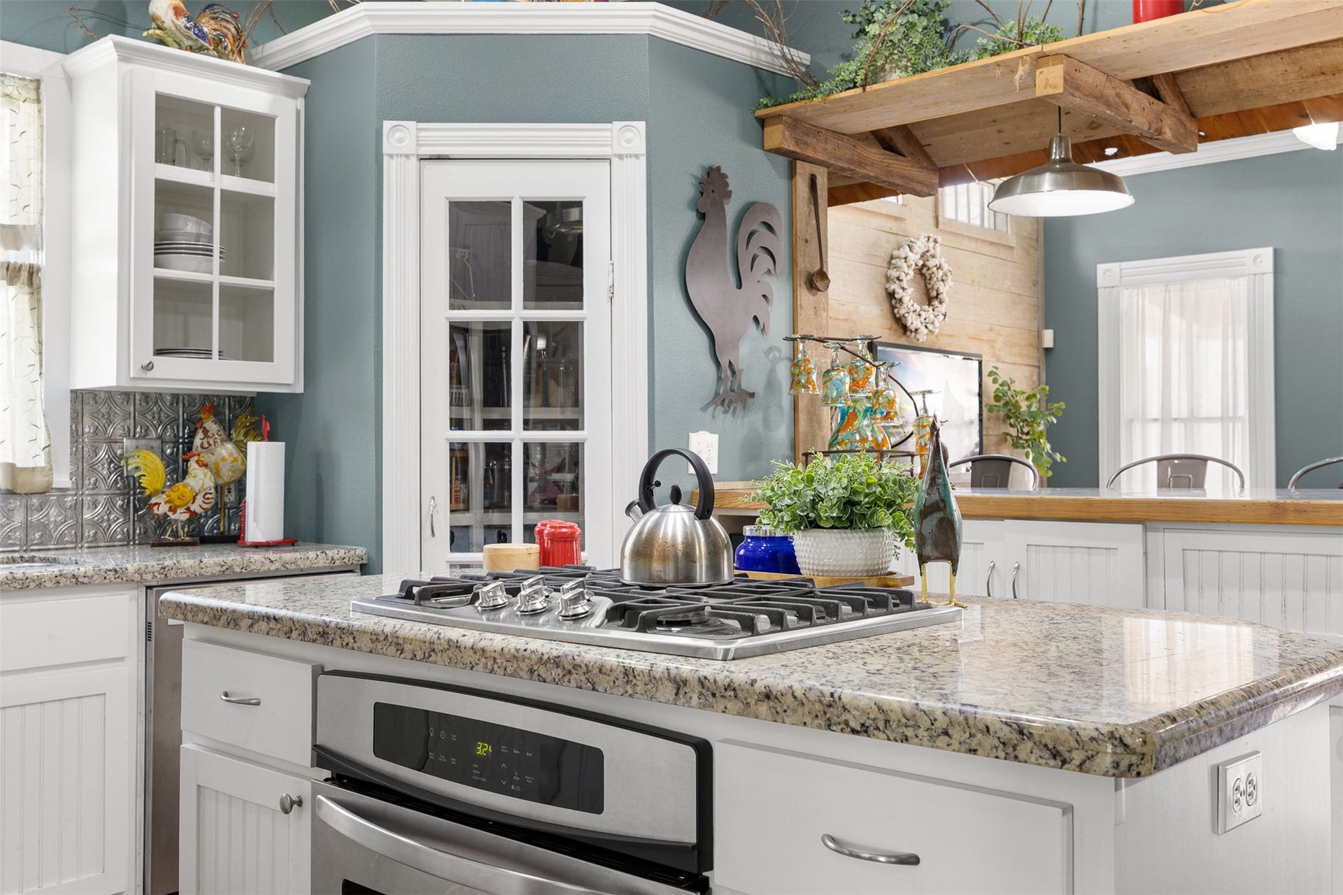 326 W Colorado Street, La Grange, TX 78945 A granite-topped island provides additional preparation space and a natural gathering place in the heart of the kitchen.