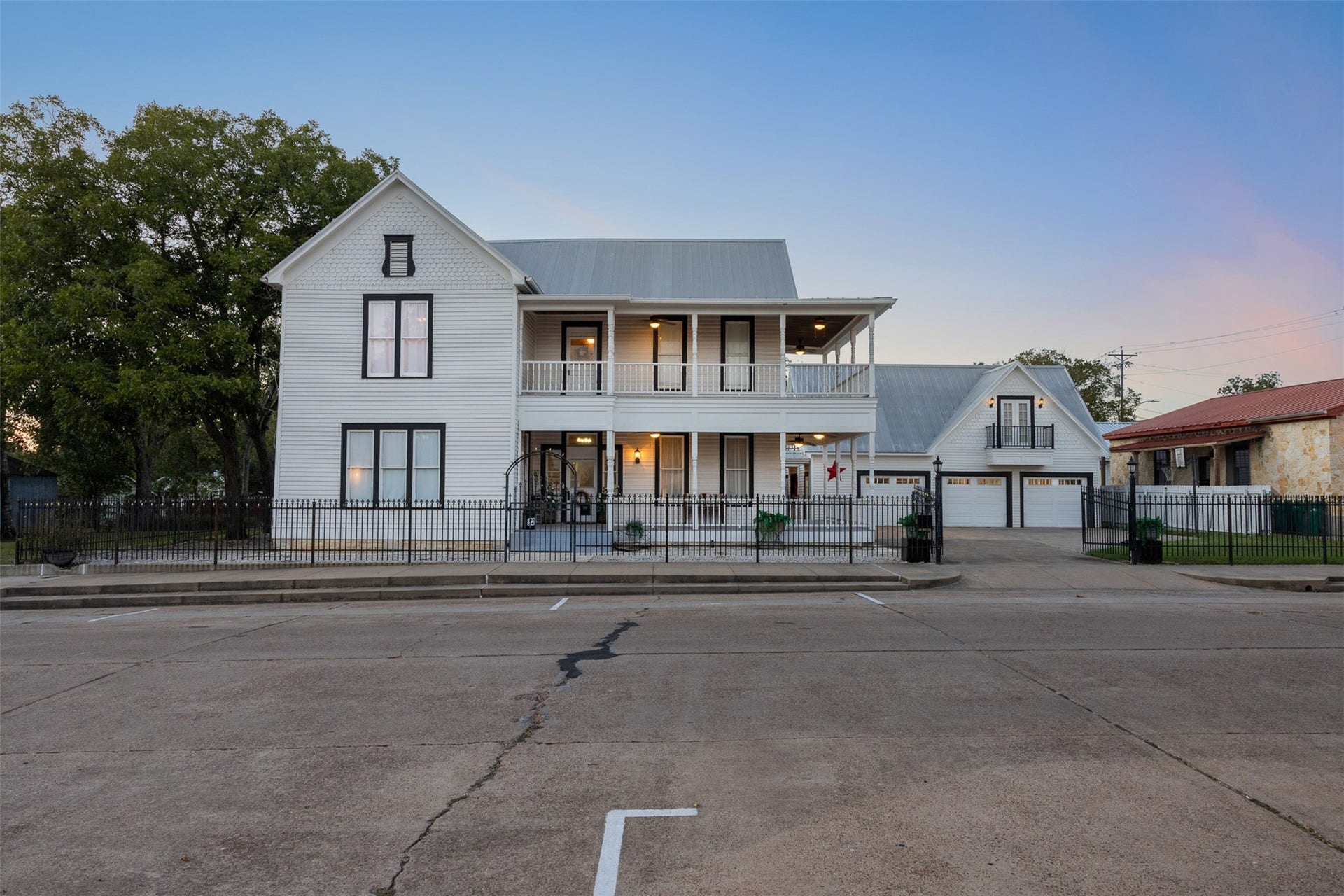 326 W Colorado Street, La Grange, TX 78945 A beautiful twilight view captures the grace, history and unmistakable presence of 326 W Colorado Street.