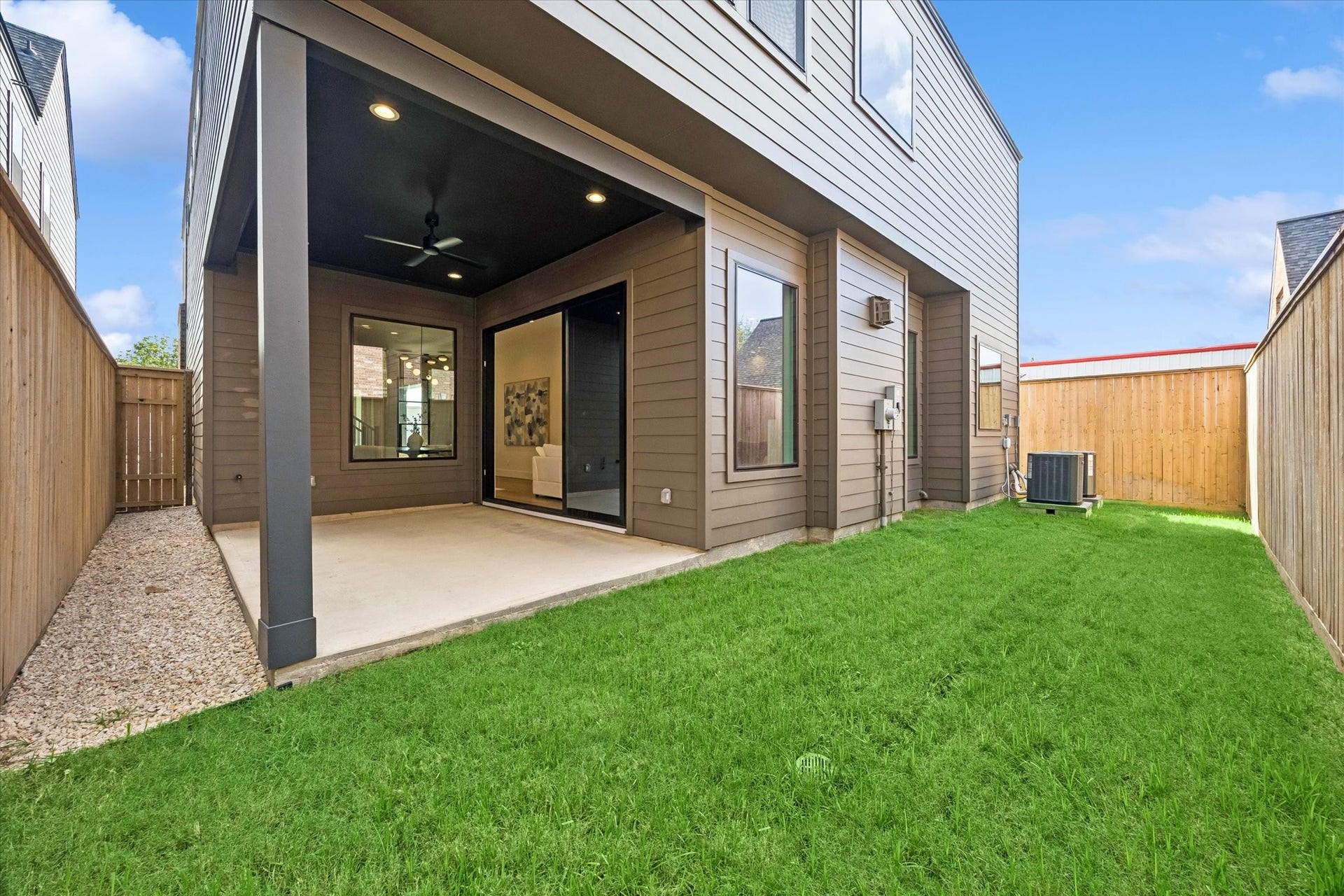 335 Harvard Street, Houston, TX 77007 Fully fenced backyard offers green space for pets, play or entertaining, complemented by a covered patio for shaded outdoor living.