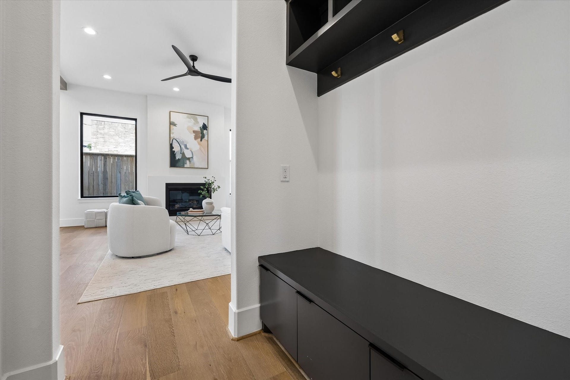 335 Harvard Street, Houston, TX 77007 Built in mudroom storage creates a polished drop zone just off the main living spaces, pairing a bench with concealed cabinetry, overhead cubbies and brass hooks for everyday organization.