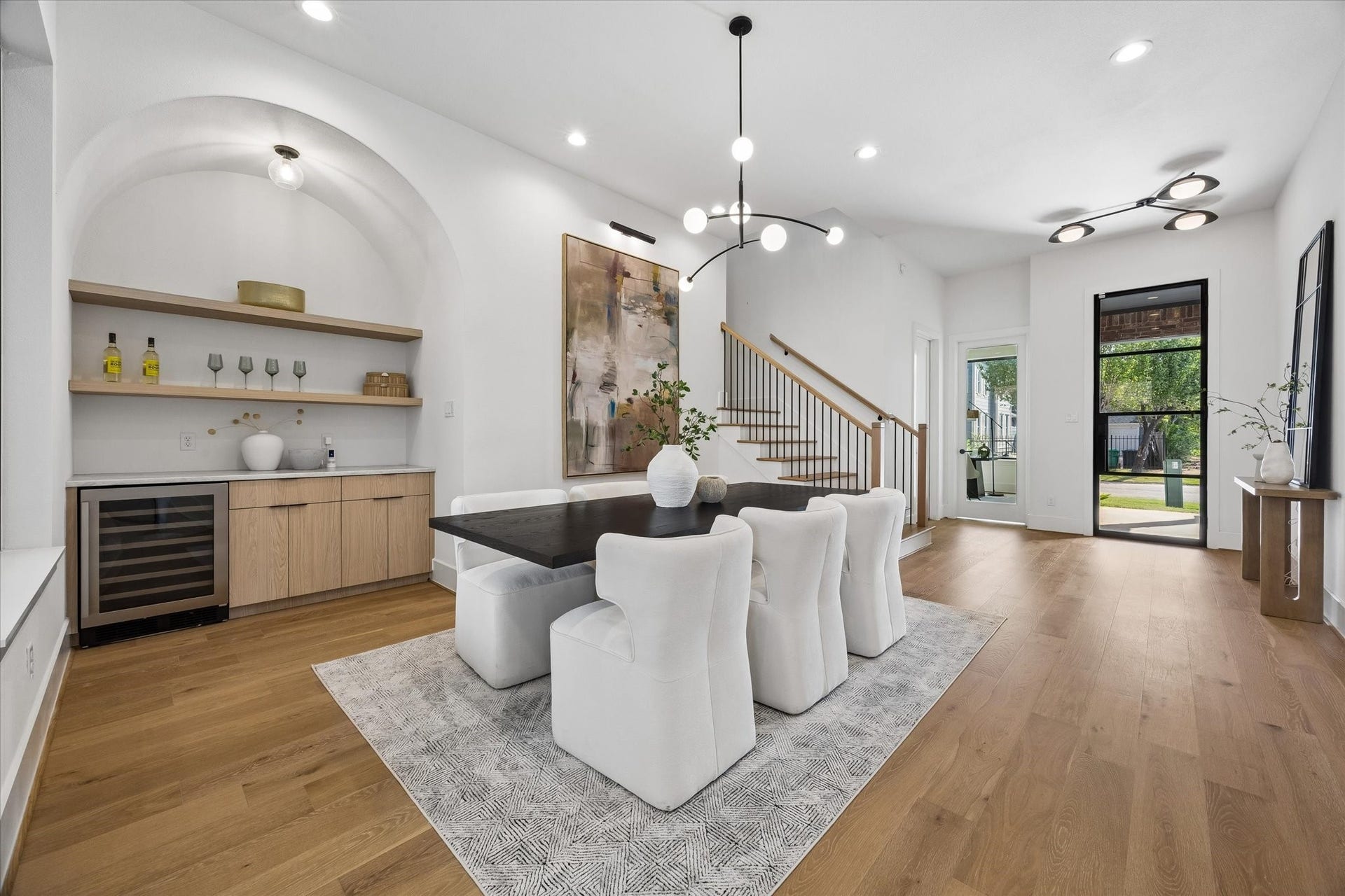 335 Harvard Street, Houston, TX 77007 An arched beverage center gives the dining room its own destination, complete with floating oak shelving, generous cabinetry and a built in wine refrigerator. Thoughtful millwork turns an everyday convenience into a polished architectural feature.