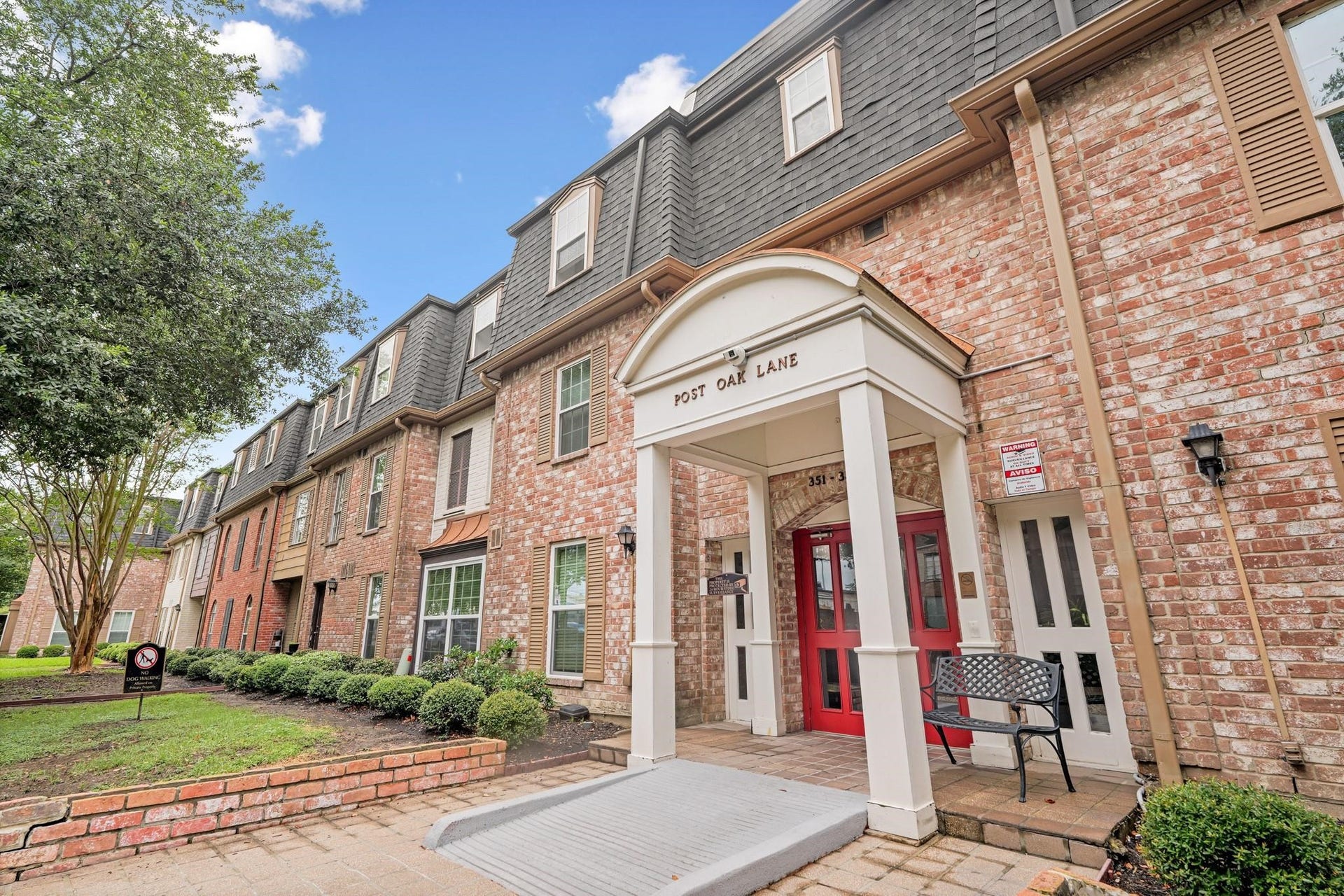 355 N Post Oak Lane, #839, Houston, TX 77024 Charming brick townhouse with classic architectural details, featuring a welcoming entrance and lush landscaping in a serene community setting.