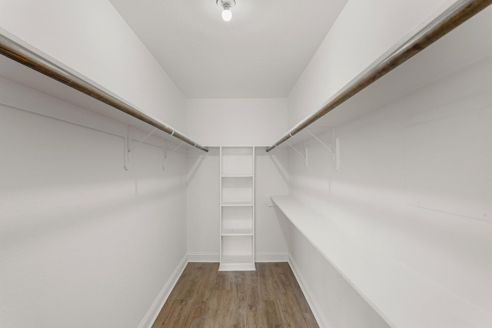 355 N Post Oak Lane, #839, Houston, TX 77024 Spacious walk-in closet featuring dual hanging rods and built-in shelving, perfect for ample storage and organization.