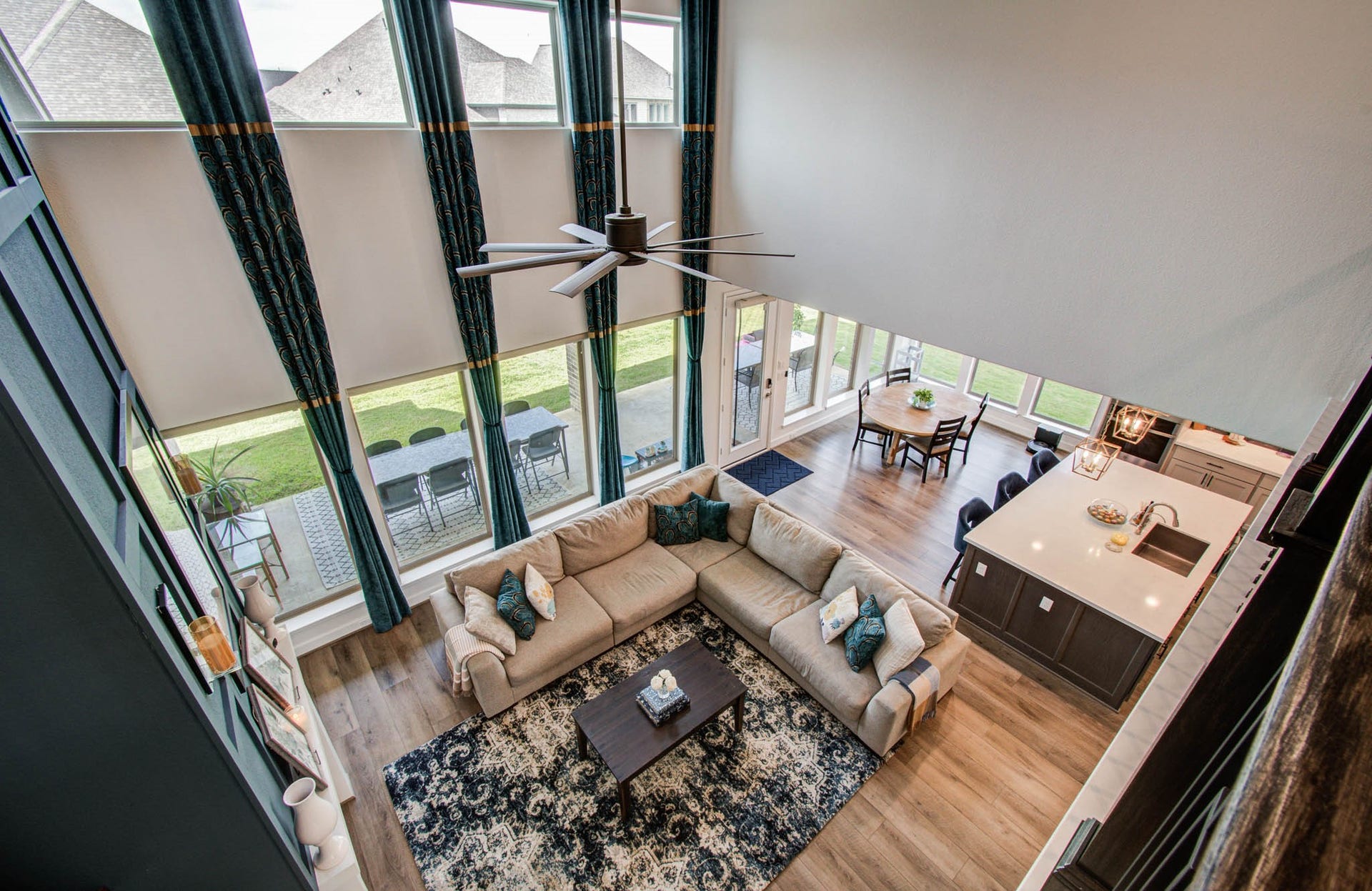 24430 Switchgrass Valley Way, Katy, TX 77493 Experience the perfect blend of space and style in this open-concept living area, featuring high ceilings and abundant natural light from floor-to-ceiling windows, seamlessly connecting to a modern kitchen and inviting dining space, ideal for family gatherings and entertaining.