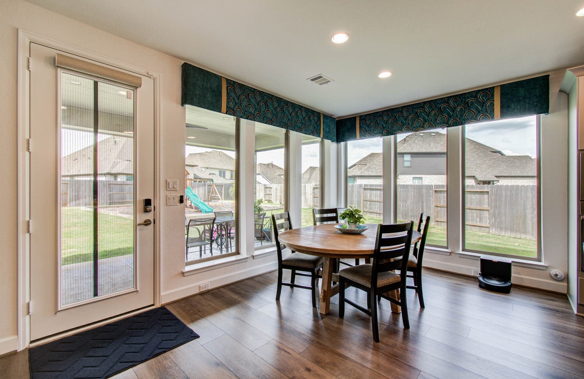 24430 Switchgrass Valley Way, Katy, TX 77493 Sunlit dining area with expansive windows framing a delightful backyard view.