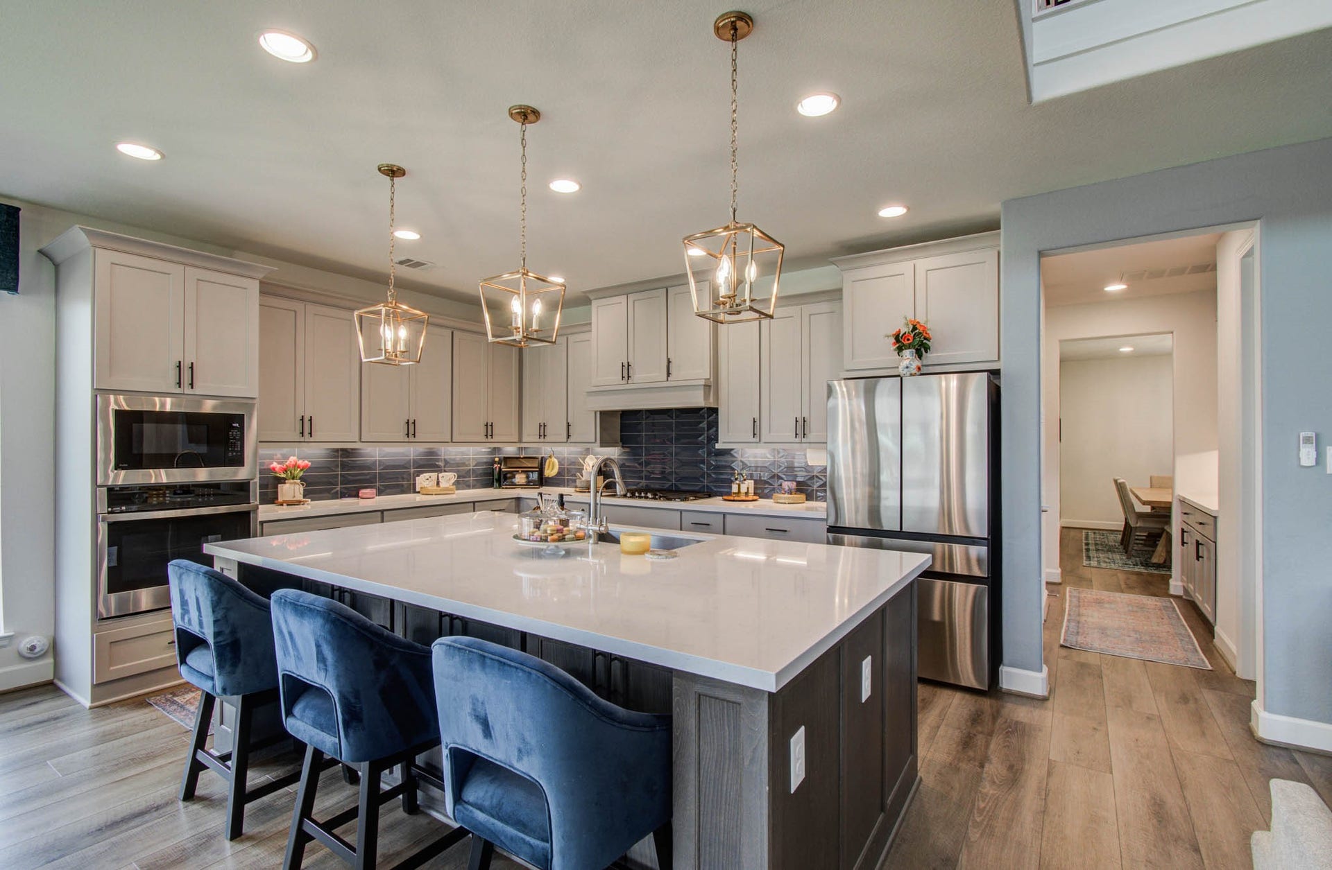 24430 Switchgrass Valley Way, Katy, TX 77493 Discover a welcoming and functional kitchen featuring a spacious island with seating, elegant pendant lighting, stainless steel appliances, and sleek cabinetry, all enhanced by an open layout and soothing neutral tones.