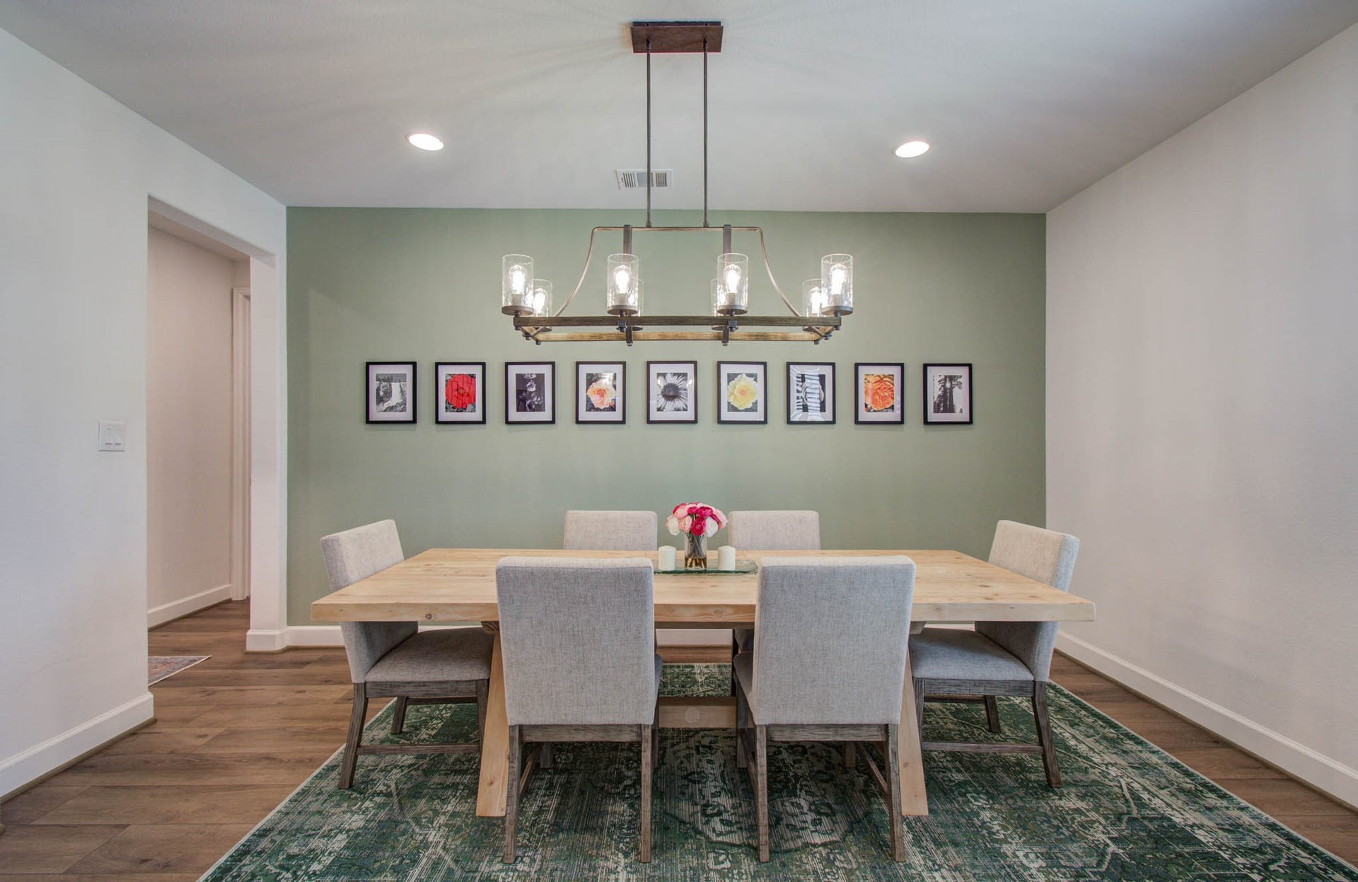 24430 Switchgrass Valley Way, Katy, TX 77493 Bright and inviting, this dining room boasts a modern chandelier complemented by recessed lighting, creating a stylish and welcoming atmosphere.
