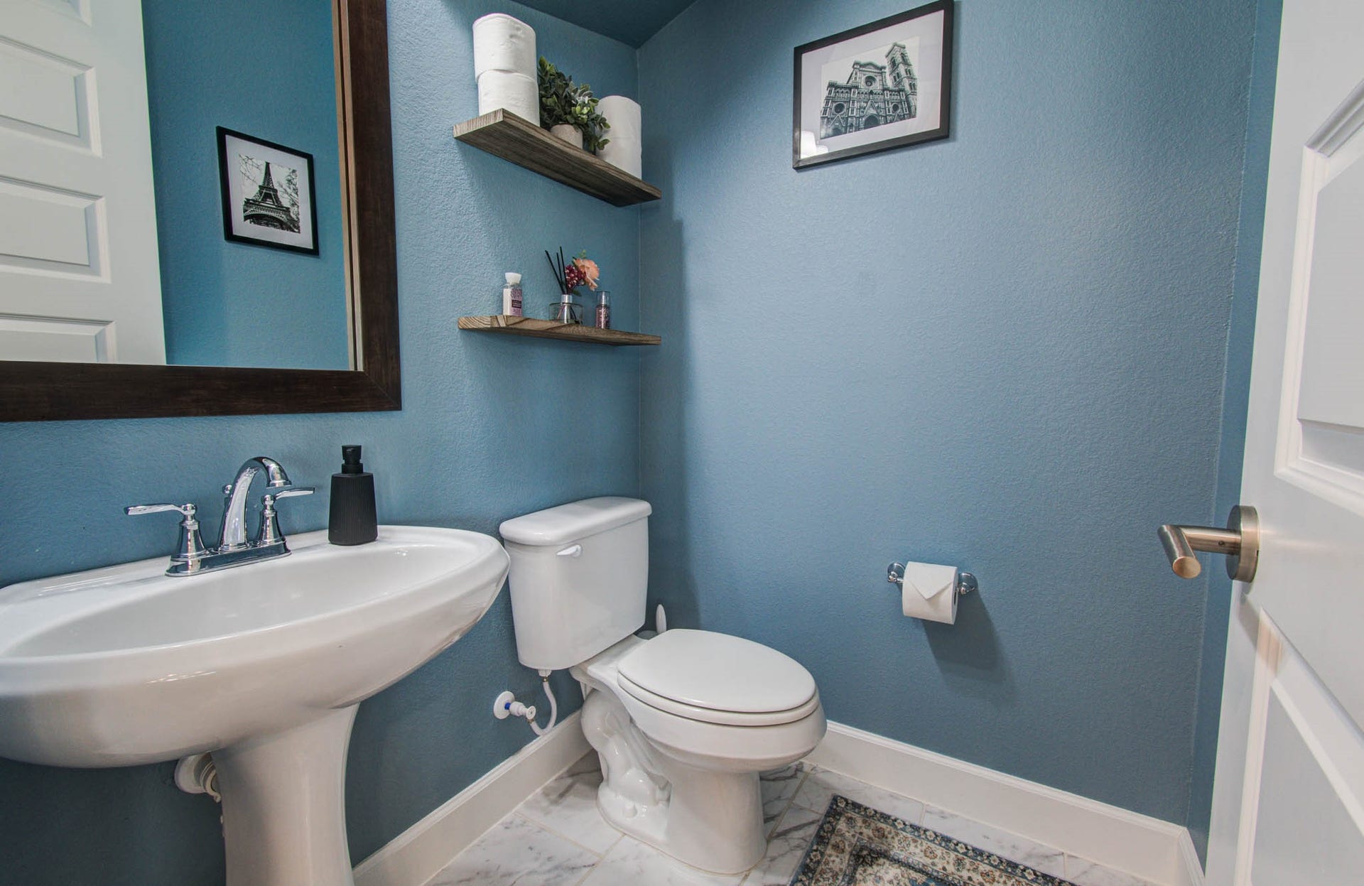 24430 Switchgrass Valley Way, Katy, TX 77493 Charming powder bathroom featuring elegant floating shelves for a stylish and functional touch.