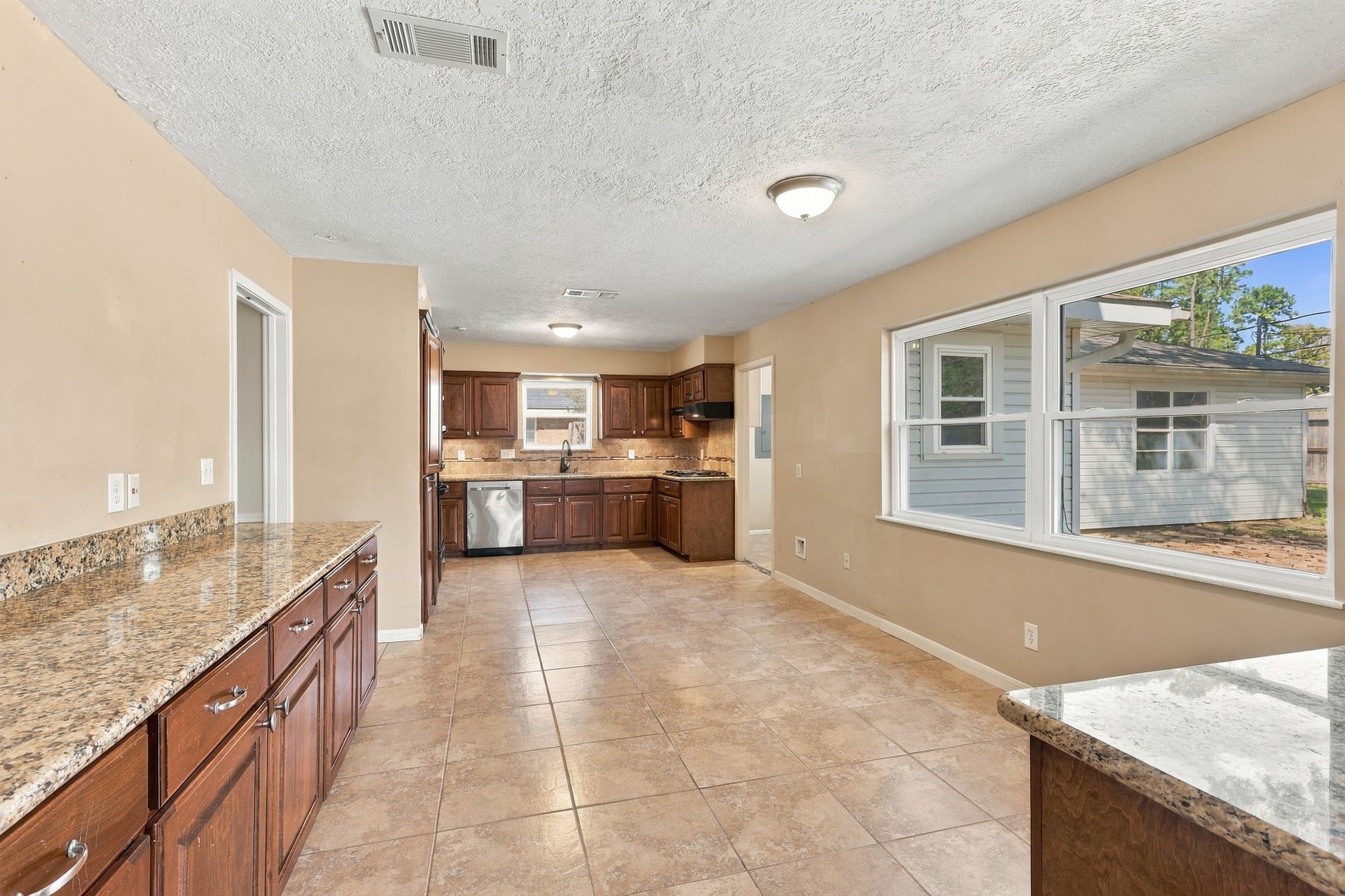 18106 Mahogany Forest Drive, Spring, TX 77379 Kitchen introduces Brown cabinetry and Granite Countertops