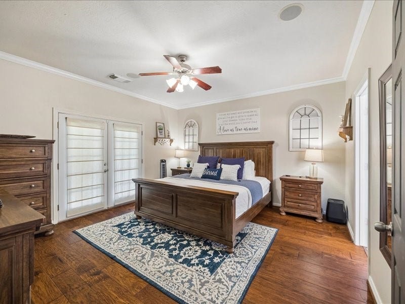 First-floor primary suite with direct access to the covered patio.