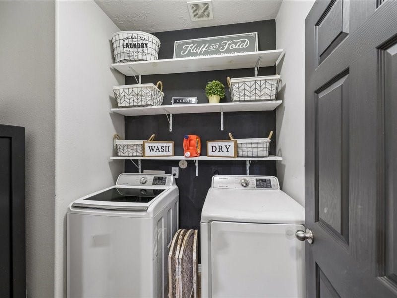 First-floor utility room with built-in shelving and storage.