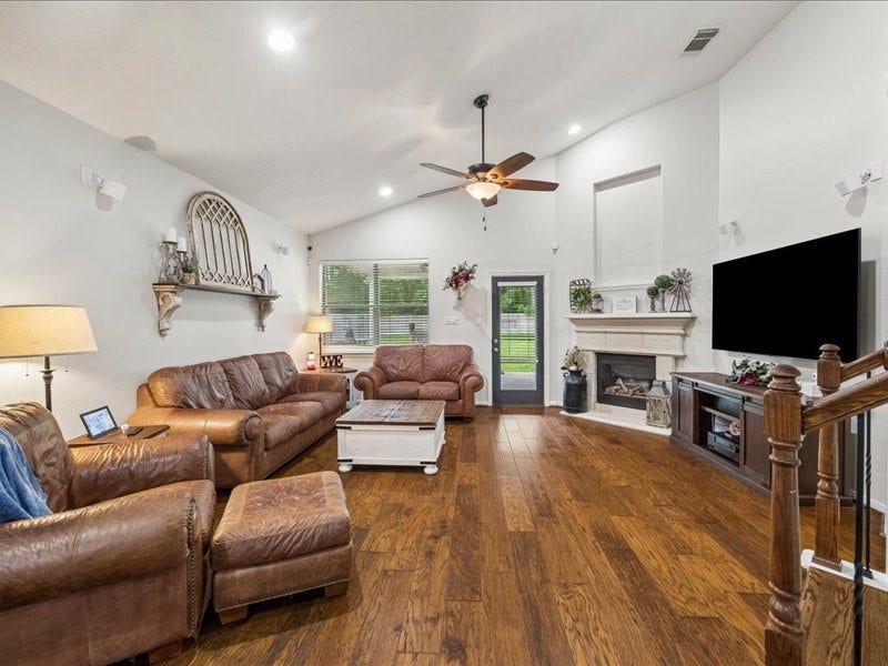 Spacious living room with high ceilings and abundant natural light.