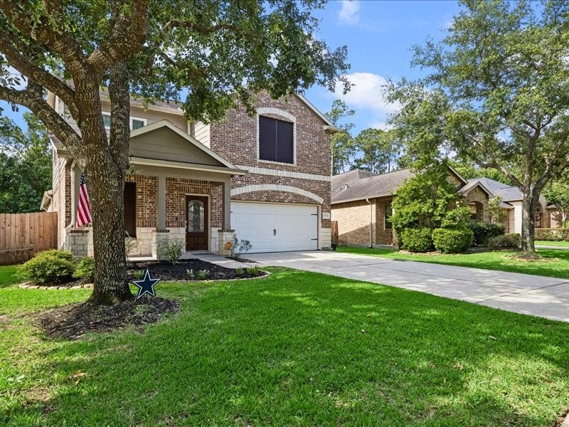 Mature shade tree, private driveway and attached two-car garage.