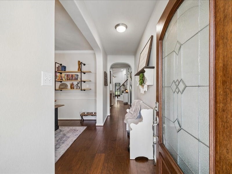 Welcoming entry with arched openings and engineered wood flooring.