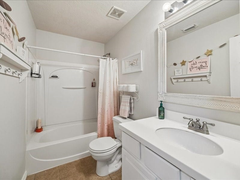 Full upstairs bathroom conveniently serves the secondary bedrooms and game room.
