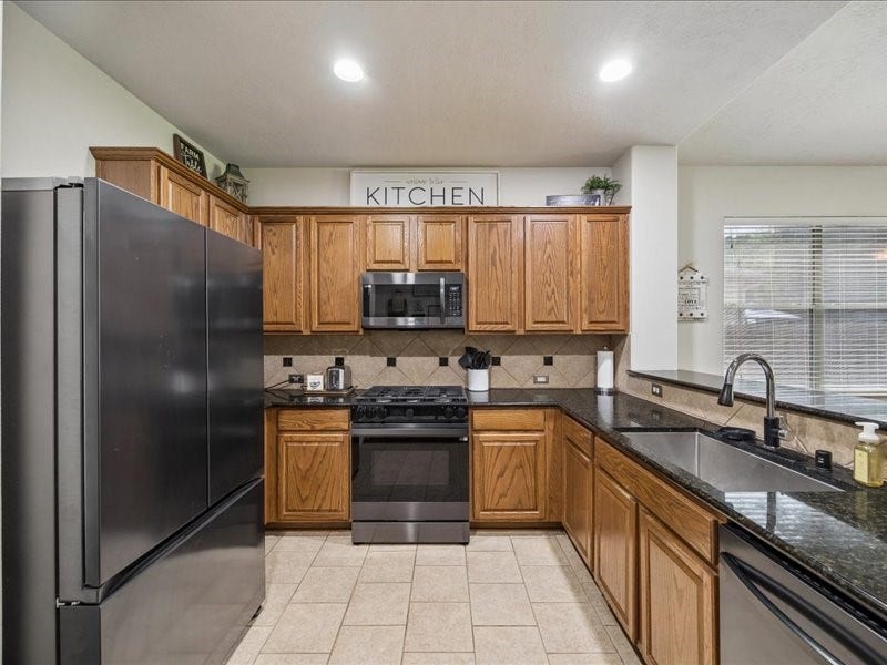 Generous cabinetry, pantry storage and ample workspace.