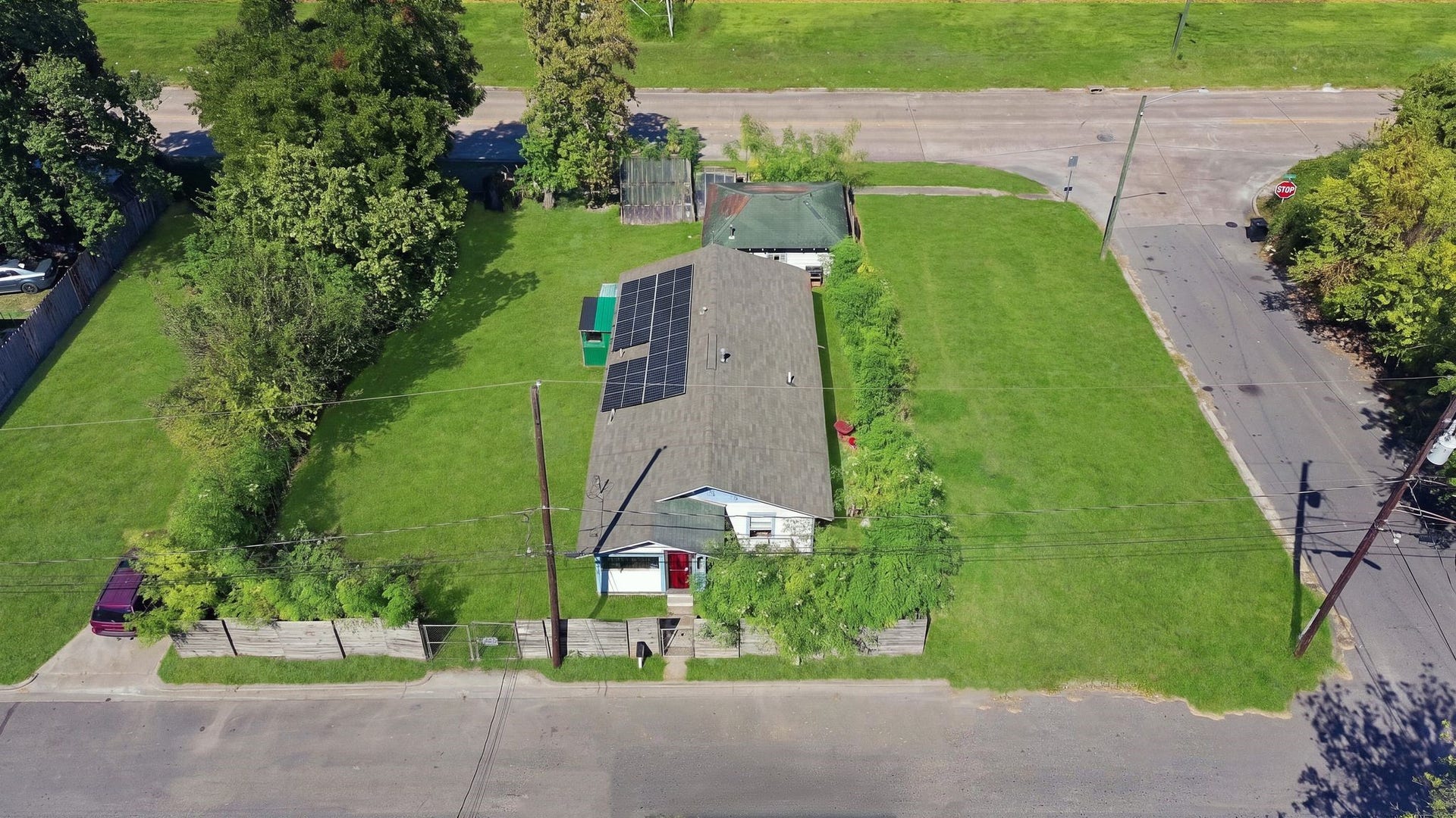1323 E 36th Street, Houston, TX 77022 Aerial view of the property showing the fenced front yard and ample green space.