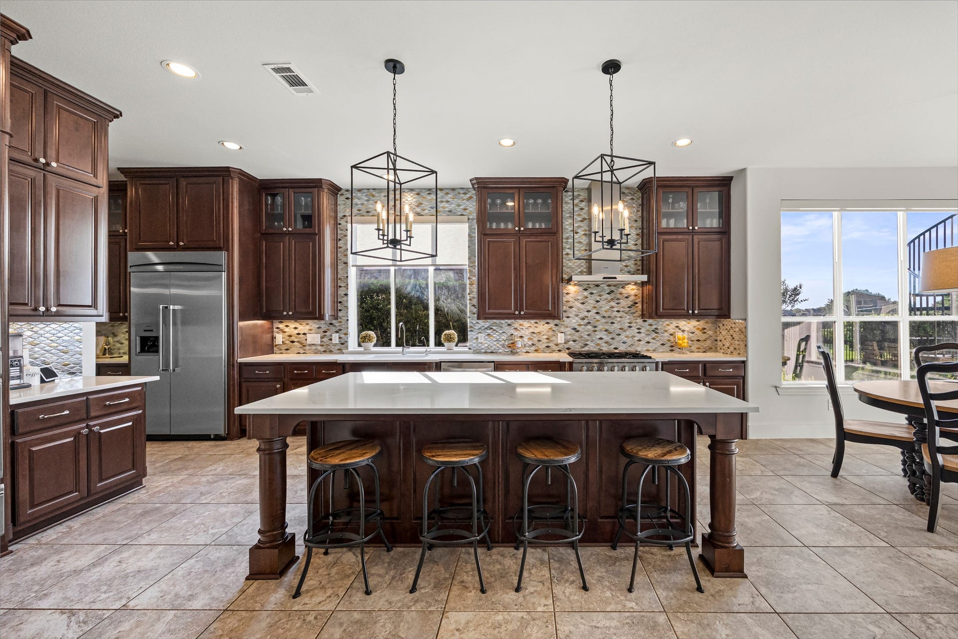8642 Chickasaw Plum Way, Katy, TX 77494 Kitchen with island seating, stainless steel appliances, and generous counter space. New quartz countertops and backsplash (2024). Kegerator and 2 beverage dispensers.