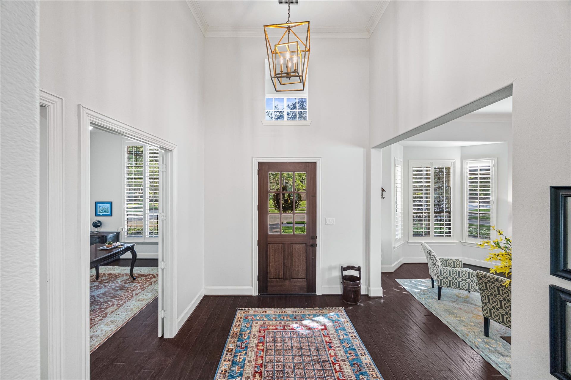 8642 Chickasaw Plum Way, Katy, TX 77494 Dramatic foyer with soaring ceilings, statement chandelier, and rich dark flooring opening to formal spaces. All new lighting on dimmers. Updated paint throughout.
