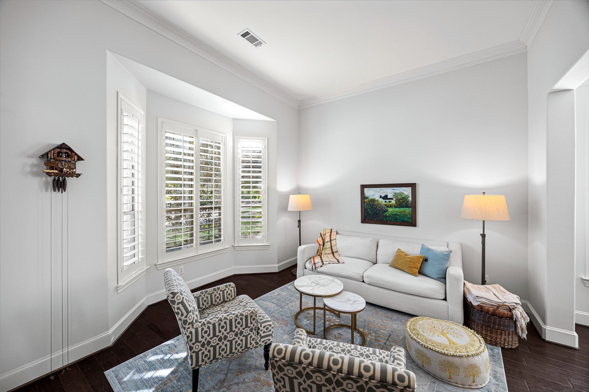 8642 Chickasaw Plum Way, Katy, TX 77494 Light-filled sitting area with plantation shutters, crisp neutral palette, and rich dark flooring. New windows (2024). All new lighting on dimmers.
