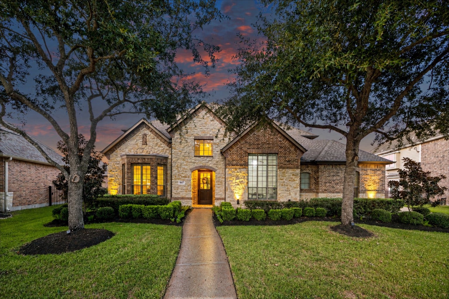8642 Chickasaw Plum Way, Katy, TX 77494 Grand front approach leading to the arched entry, framed by mature oaks.