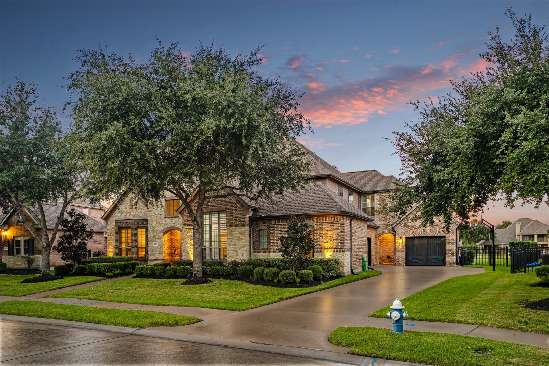 8642 Chickasaw Plum Way, Katy, TX 77494 Elegant curb appeal with sweeping driveway, lush lawn, and mature tree canopy. New windows (2024). (Virtually enhanced: driveway reflection)