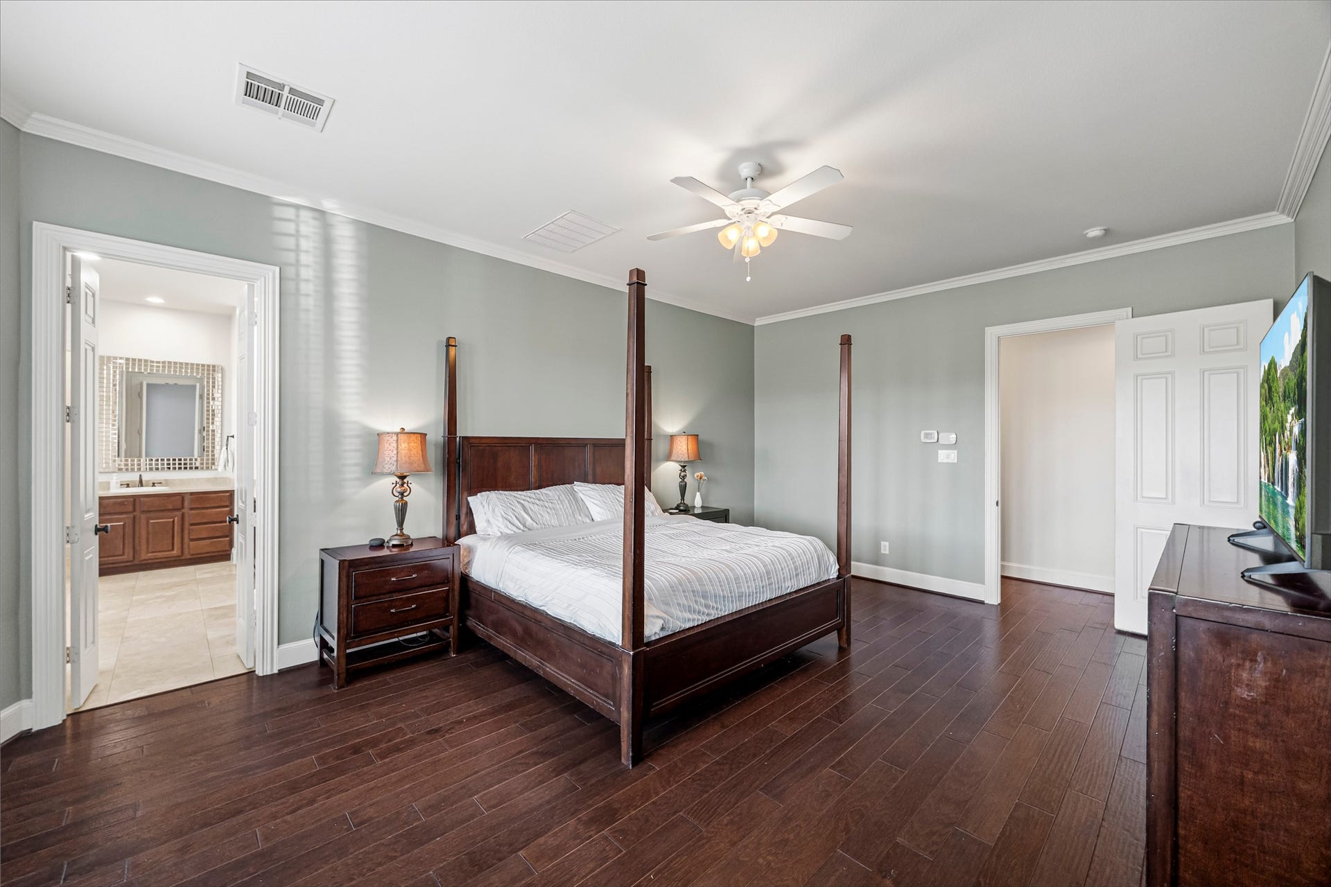 8642 Chickasaw Plum Way, Katy, TX 77494 Primary bedroom retreat with abundant natural light and access to the en suite bath. New windows (2024). Updated paint throughout.