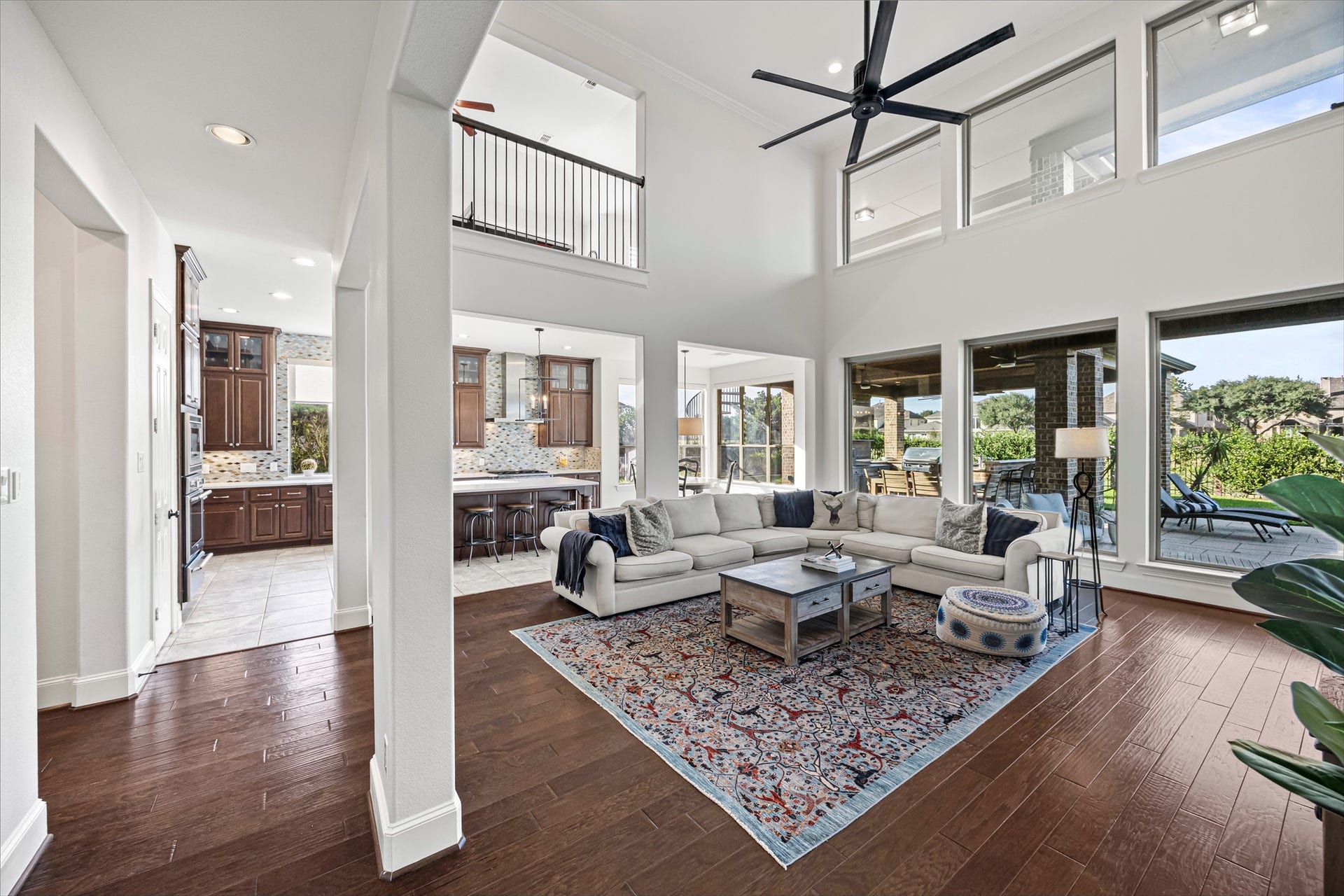 8642 Chickasaw Plum Way, Katy, TX 77494 Open living area with soaring ceilings and walls of windows bringing in natural light. New windows (2024). All new lighting on dimmers.