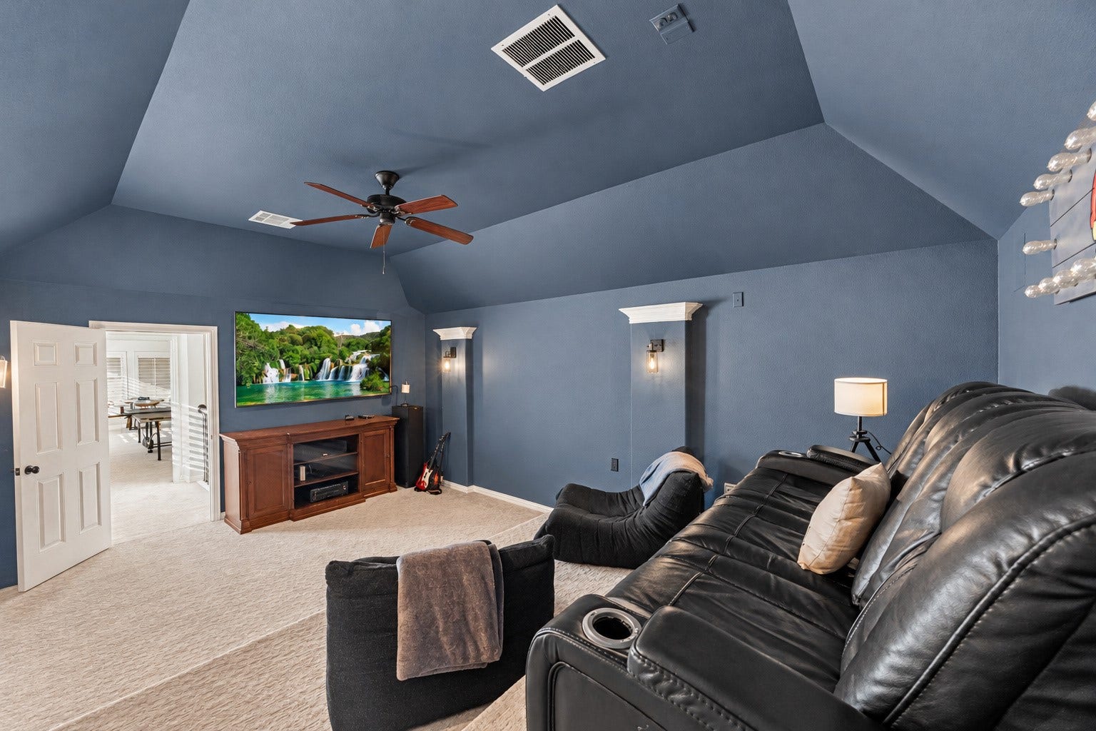 8642 Chickasaw Plum Way, Katy, TX 77494 Media room with tray ceiling, ceiling fan, and generous space for theater-style seating. Built-in speakers in media room.