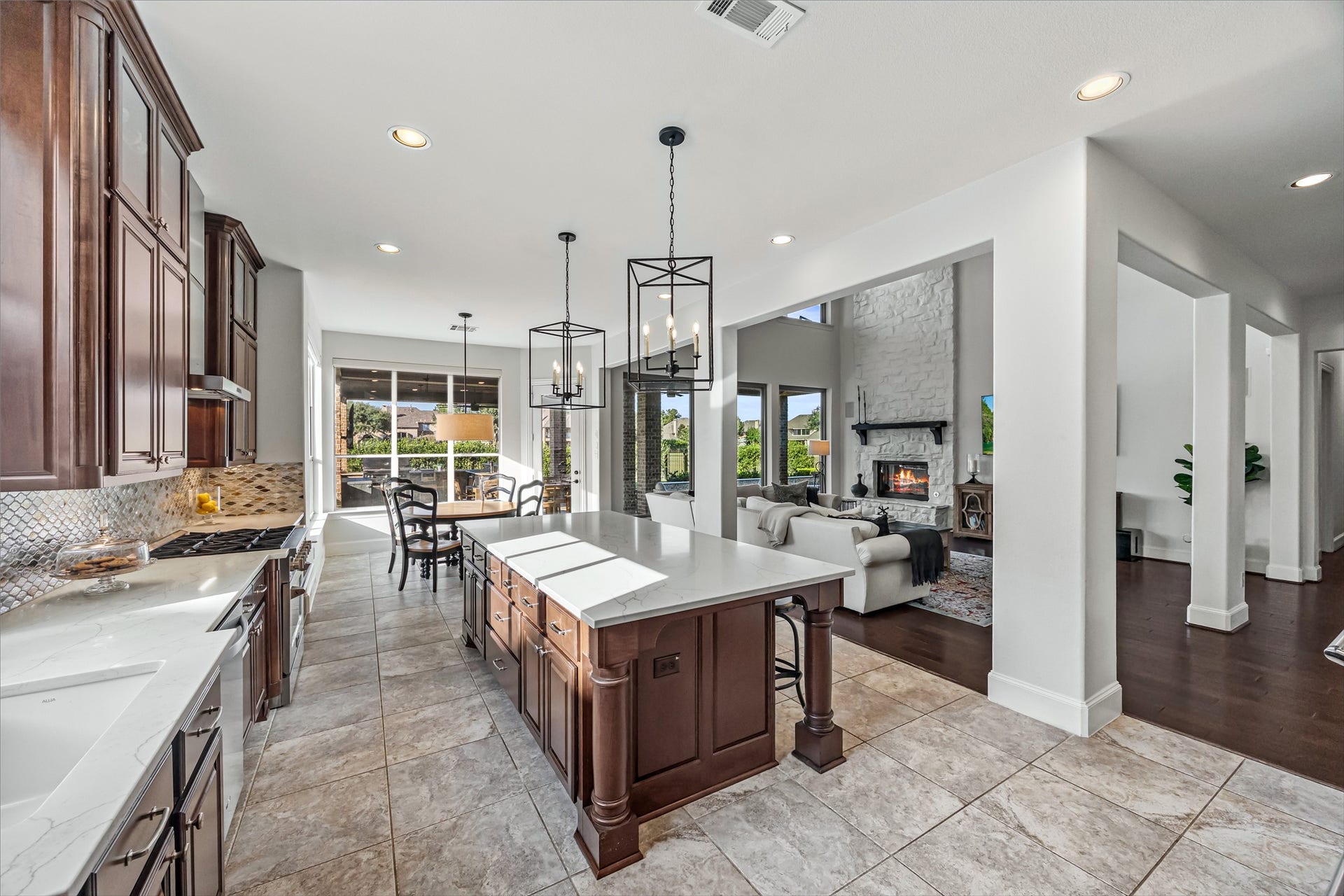 8642 Chickasaw Plum Way, Katy, TX 77494 Chef's kitchen with large center island opening to the breakfast and living areas. New quartz countertops and backsplash (2024). Reverse osmosis tied into sink and ice machine.
