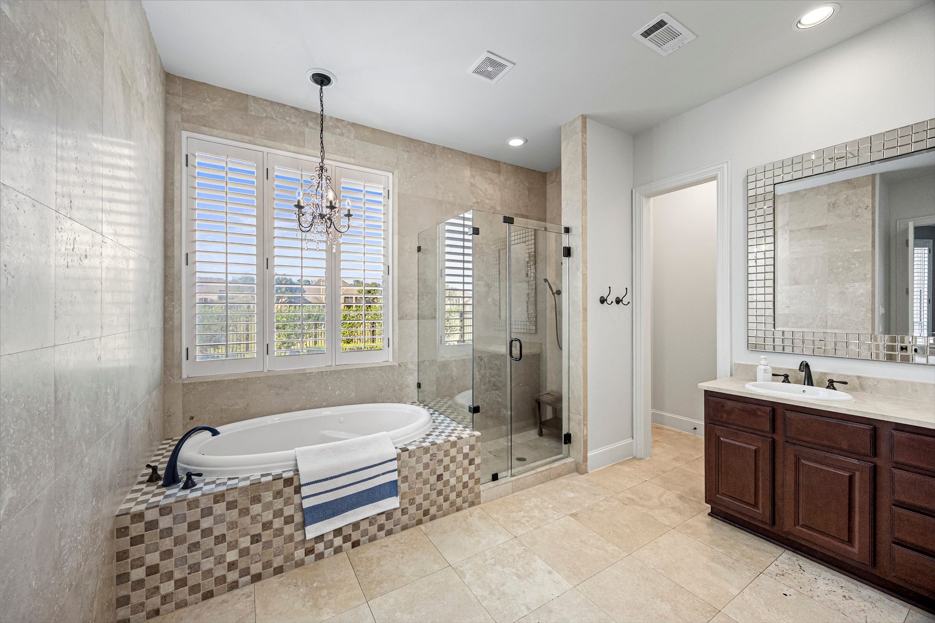 8642 Chickasaw Plum Way, Katy, TX 77494 Spa-inspired primary bath with freestanding soaking tub and elegant chandelier. All new lighting on dimmers. Updated paint throughout.