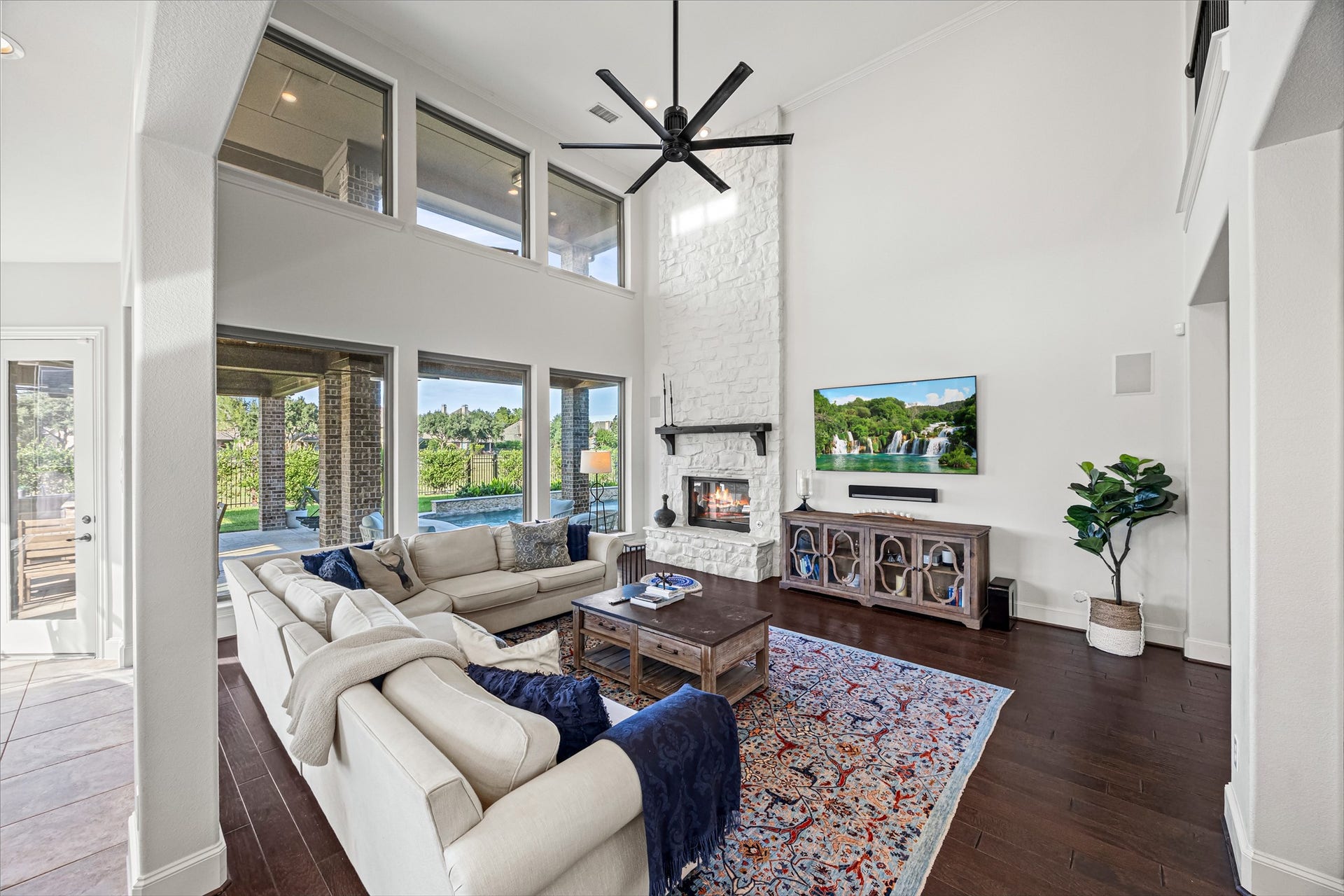 8642 Chickasaw Plum Way, Katy, TX 77494 Showpiece living room with soaring ceilings, a wall of windows, and sweeping backyard views. New windows (2024). Built-in speakers and Big Ass Fan controlled by Nest.