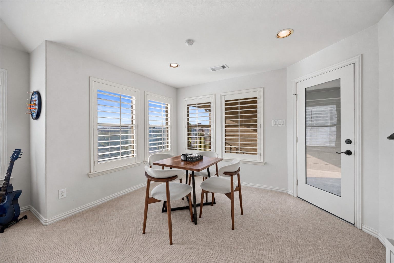 8642 Chickasaw Plum Way, Katy, TX 77494 Versatile flex area with multiple windows, plantation shutters, and a glass door leading to the balcony.