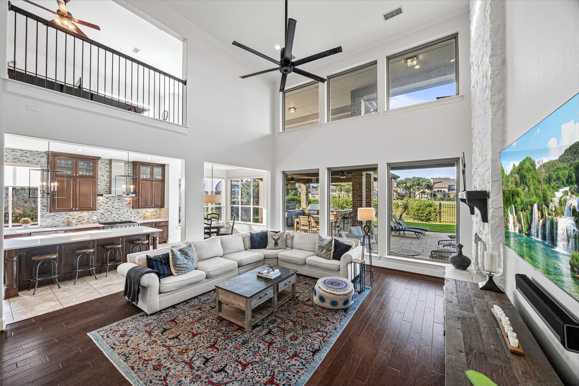 8642 Chickasaw Plum Way, Katy, TX 77494 Two-story living room with dramatic upper-level overlook and abundant natural light. New windows (2024). Built-in speakers in living room.