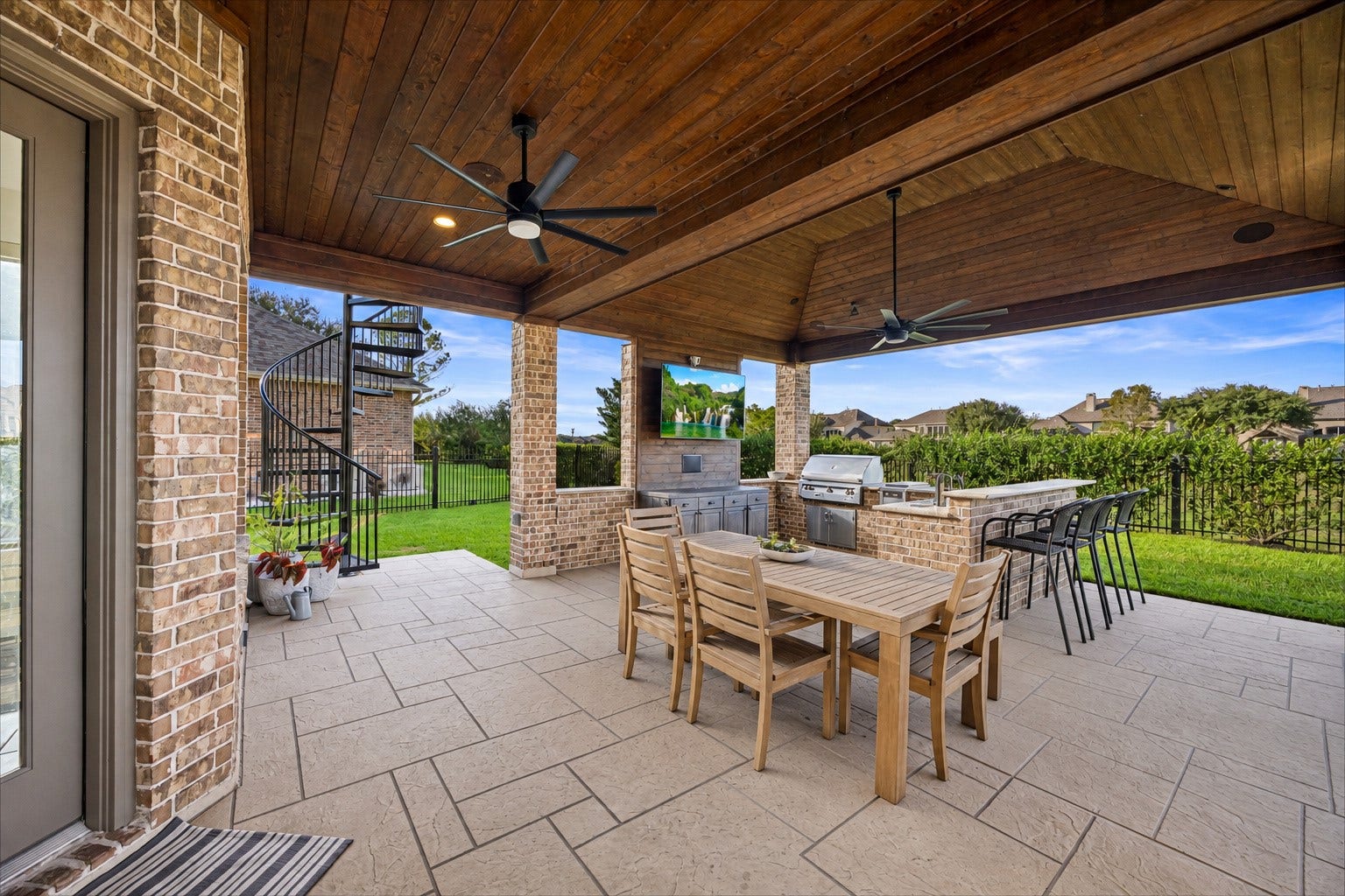 8642 Chickasaw Plum Way, Katy, TX 77494 Covered patio with ceiling fan, outdoor dining space, and sweeping backyard views. Fans, exterior surround sound, and roller shades.