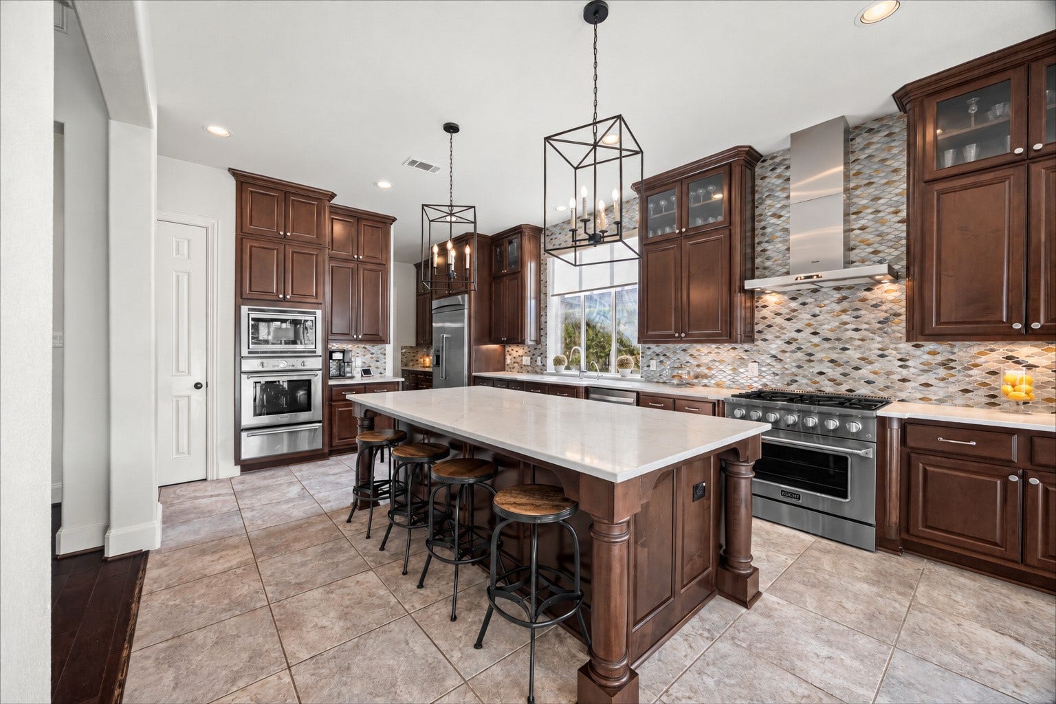 8642 Chickasaw Plum Way, Katy, TX 77494 Gourmet kitchen with center island, pendant lighting, and extensive cabinet storage. New quartz countertops and backsplash (2024). Built-in Thermador fridge and large farm sink.
