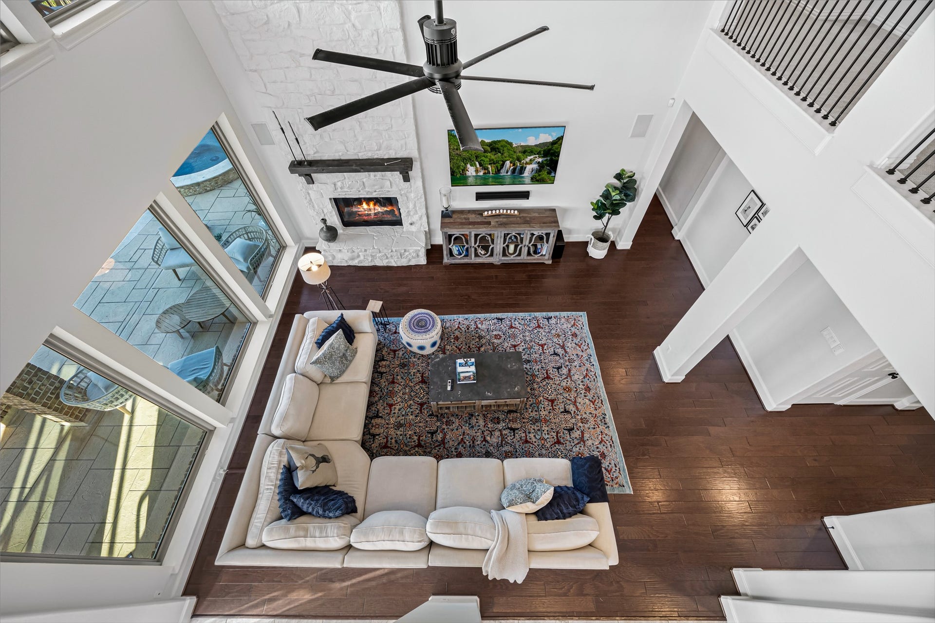8642 Chickasaw Plum Way, Katy, TX 77494 Dramatic view from the upper level overlooking the two-story living room. Stairs redone (2020). All new lighting on dimmers.