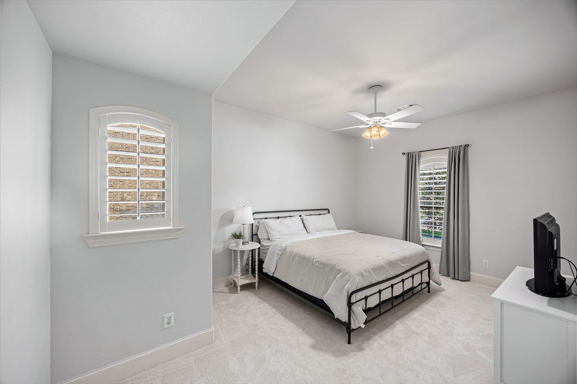 8642 Chickasaw Plum Way, Katy, TX 77494 Serene bedroom with plantation shutters, ceiling fan, and plush carpet. New windows (2024). Updated paint throughout.